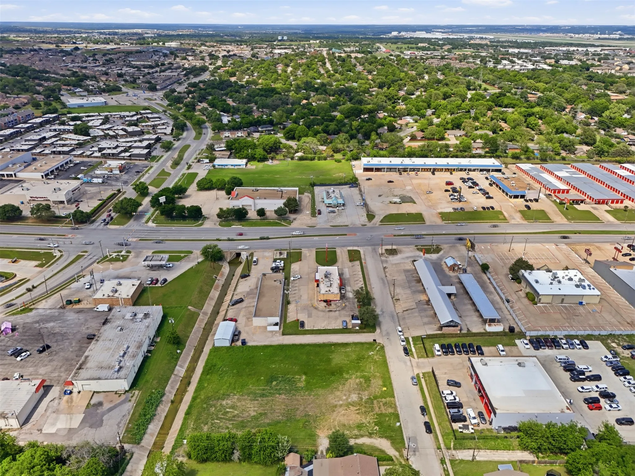 Aerial perspective showcasing a mixed-use commercial and residential district with established infrastructure