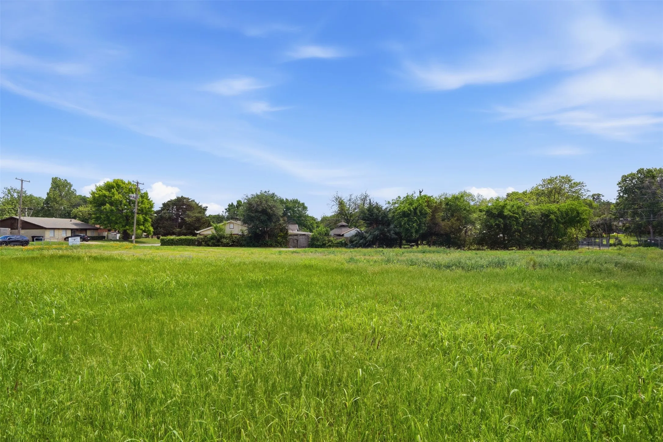 Expansive green space featuring natural foliage and a clear horizon
