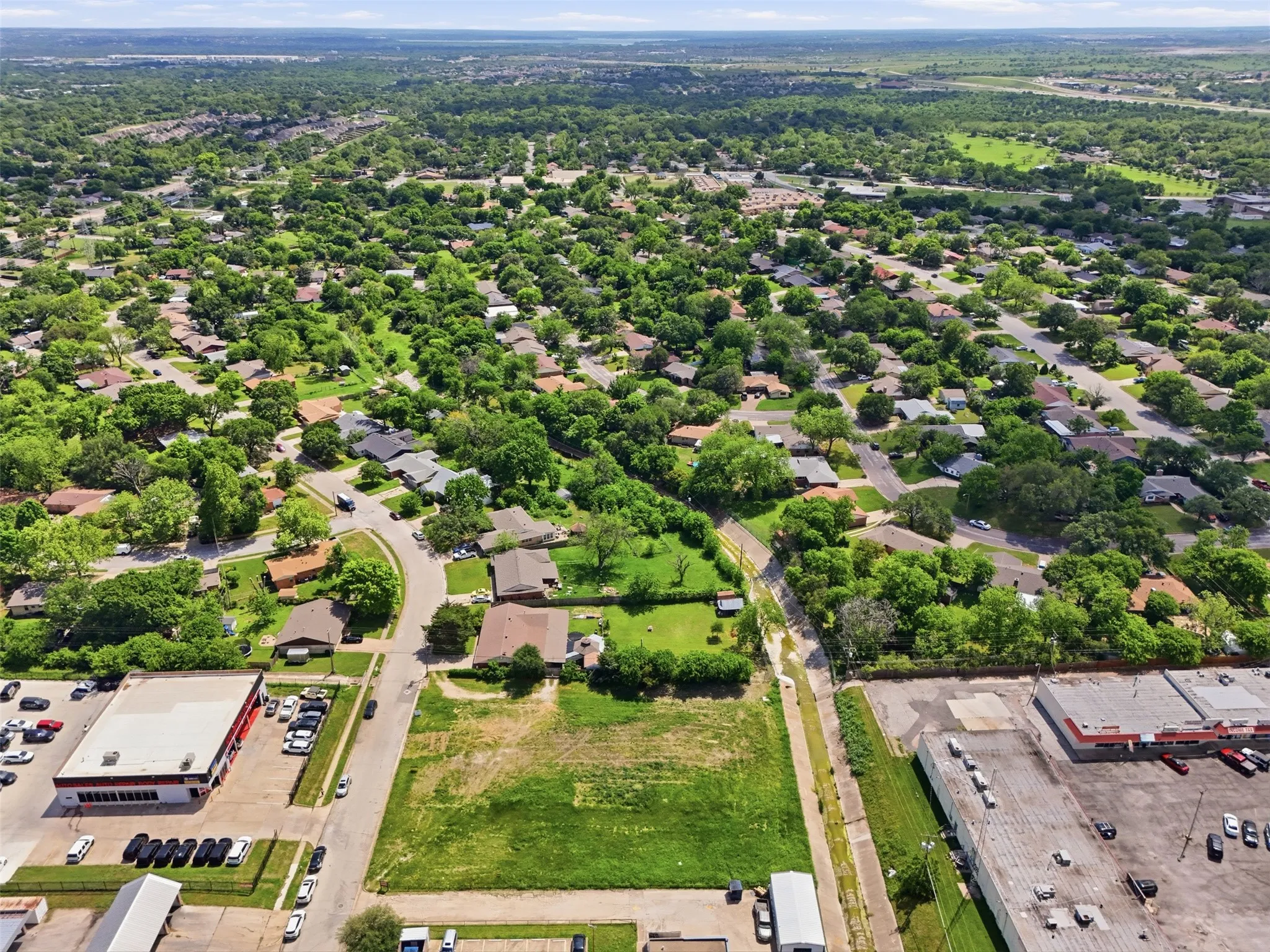 Expansive land parcel featuring a grass field and direct road frontage