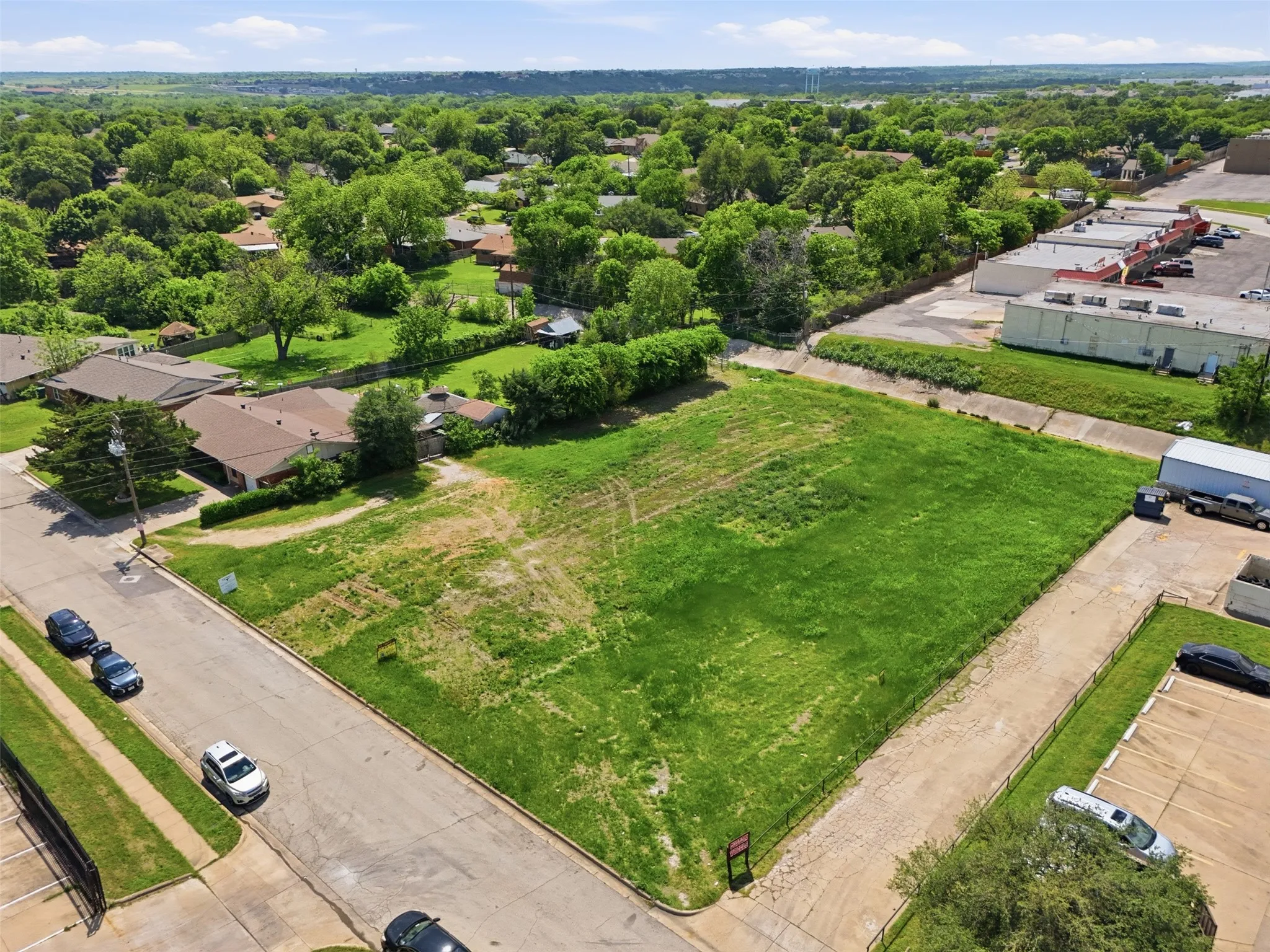 Expansive corner lot featuring a flat, cleared parcel with street frontage on two sides
