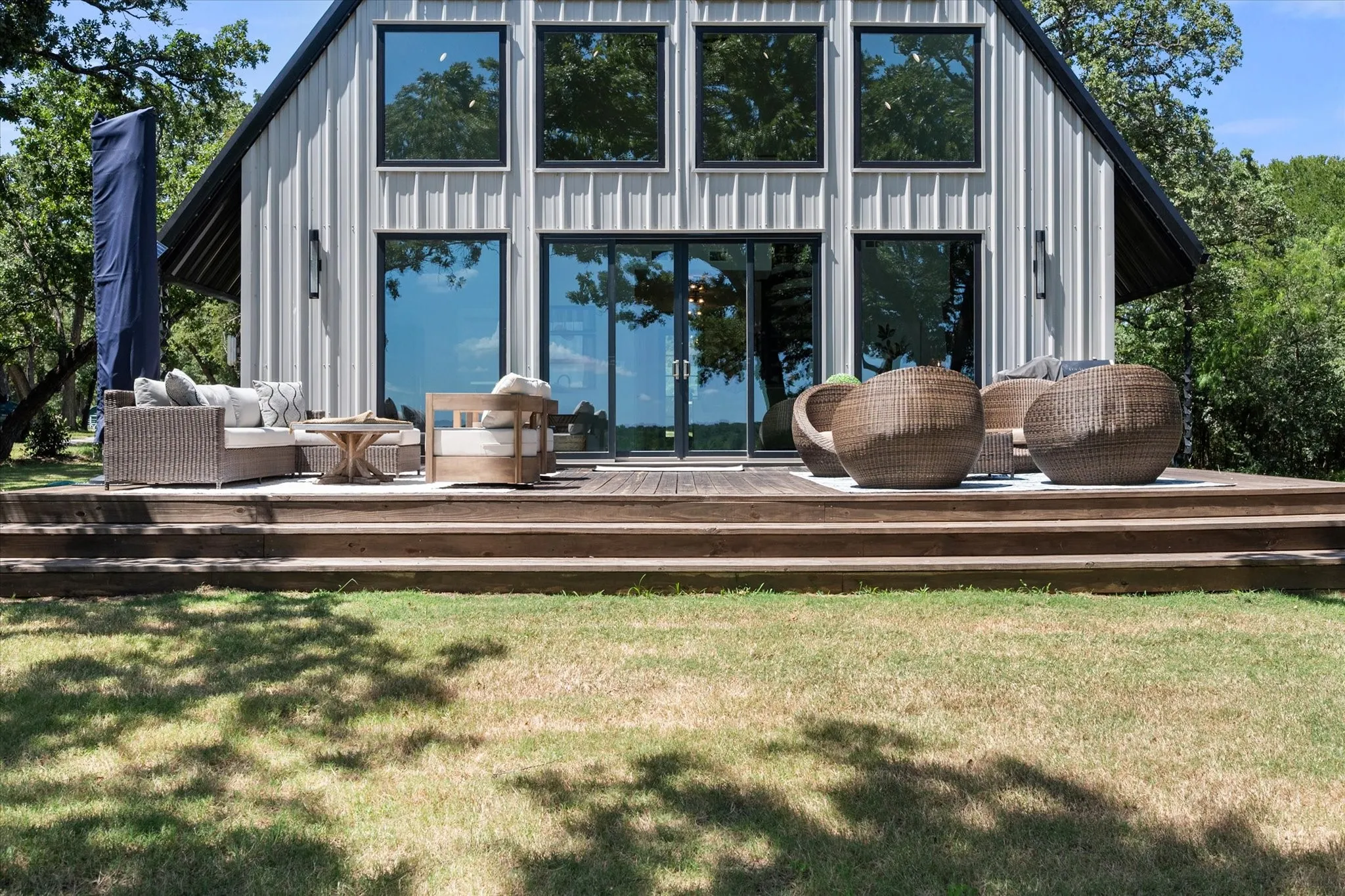 Expansive entertainment deck is designed for relaxing and hosting lakeside gatherings.