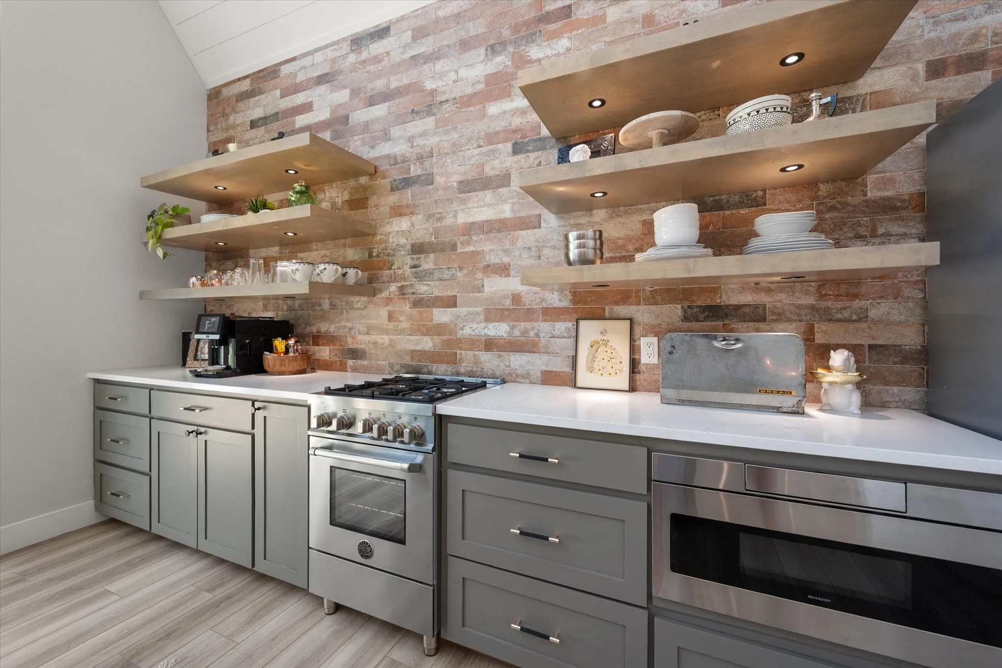 Designer kitchen showcases custom cabinetry, floating shelves, and stylish modern finishes.