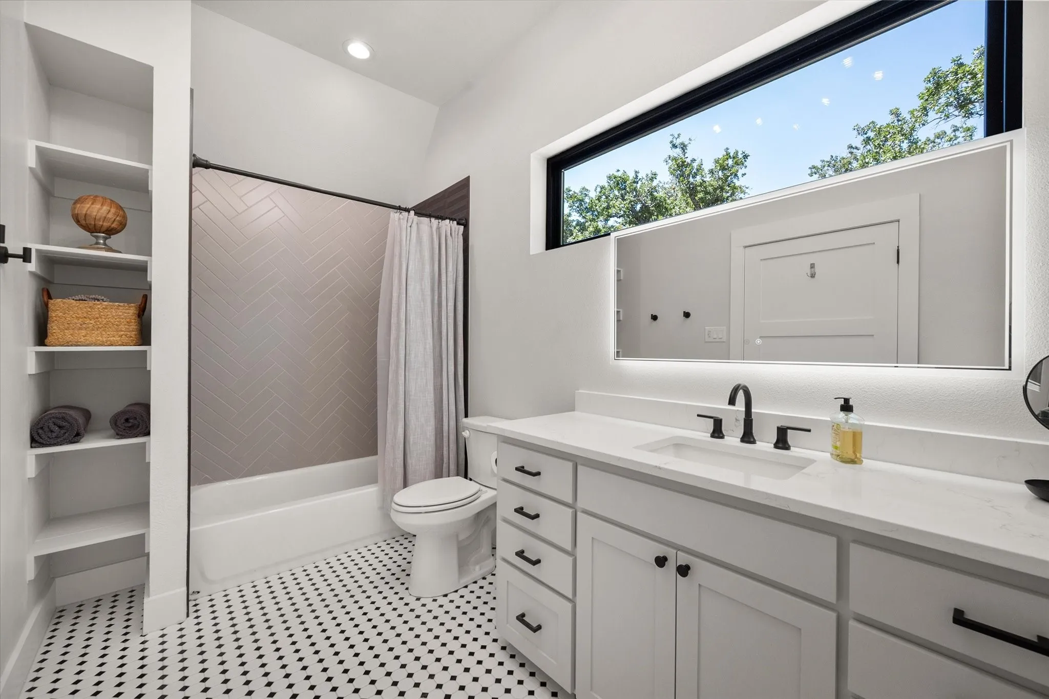 Private ensuite bathroom serves the loft primary suite with contemporary finishes.