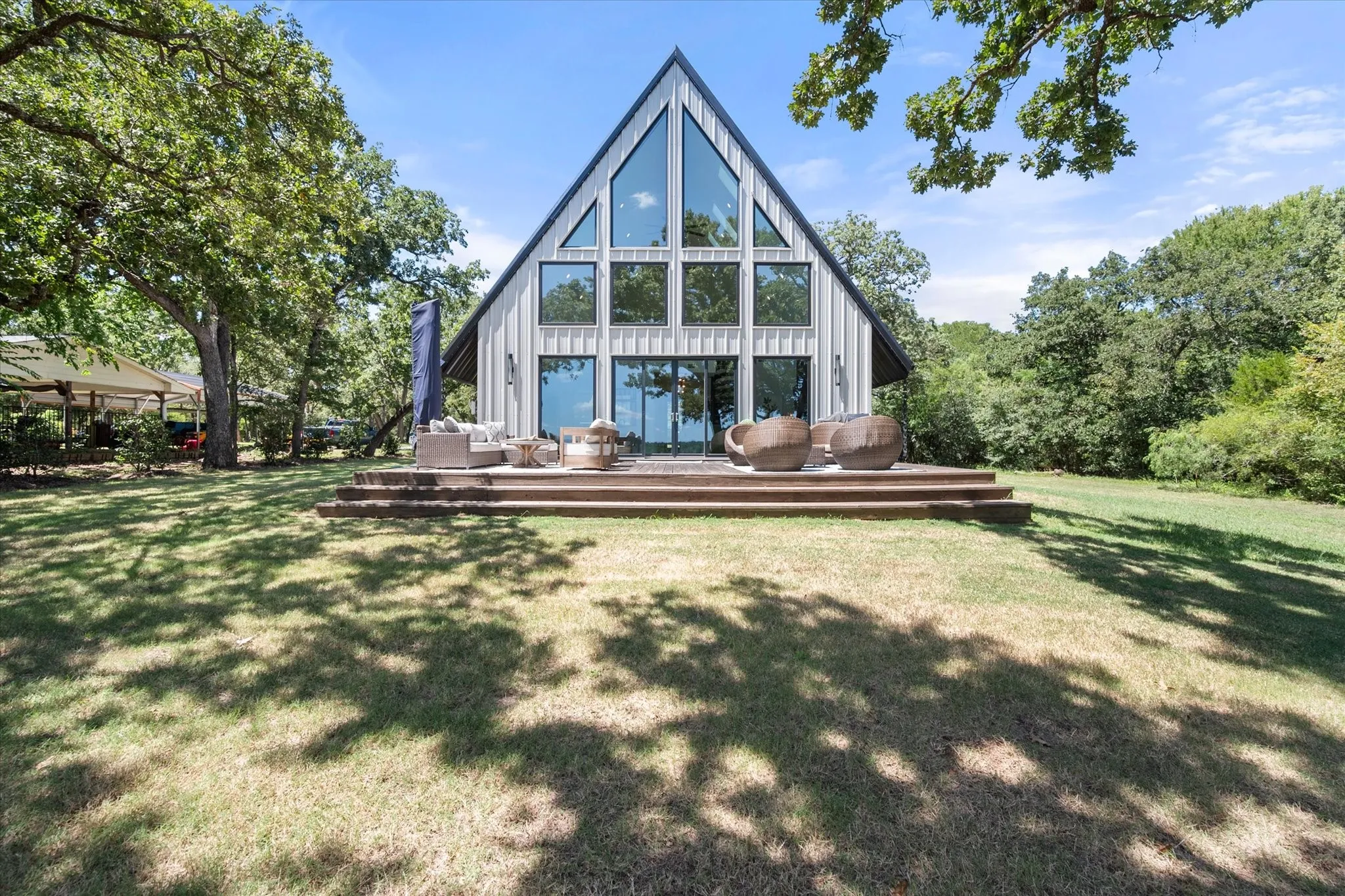 Rear elevation showcases the home's impressive wall of windows facing Richland Chambers Lake.