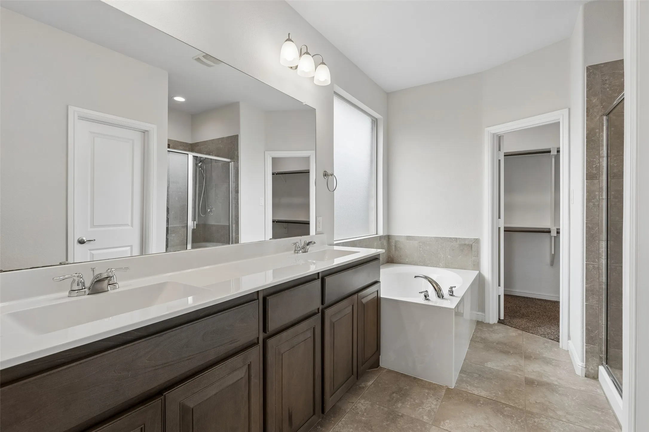 Large master suite with separate tiled shower, dual sinks, garden tub and a very large walk in closet.