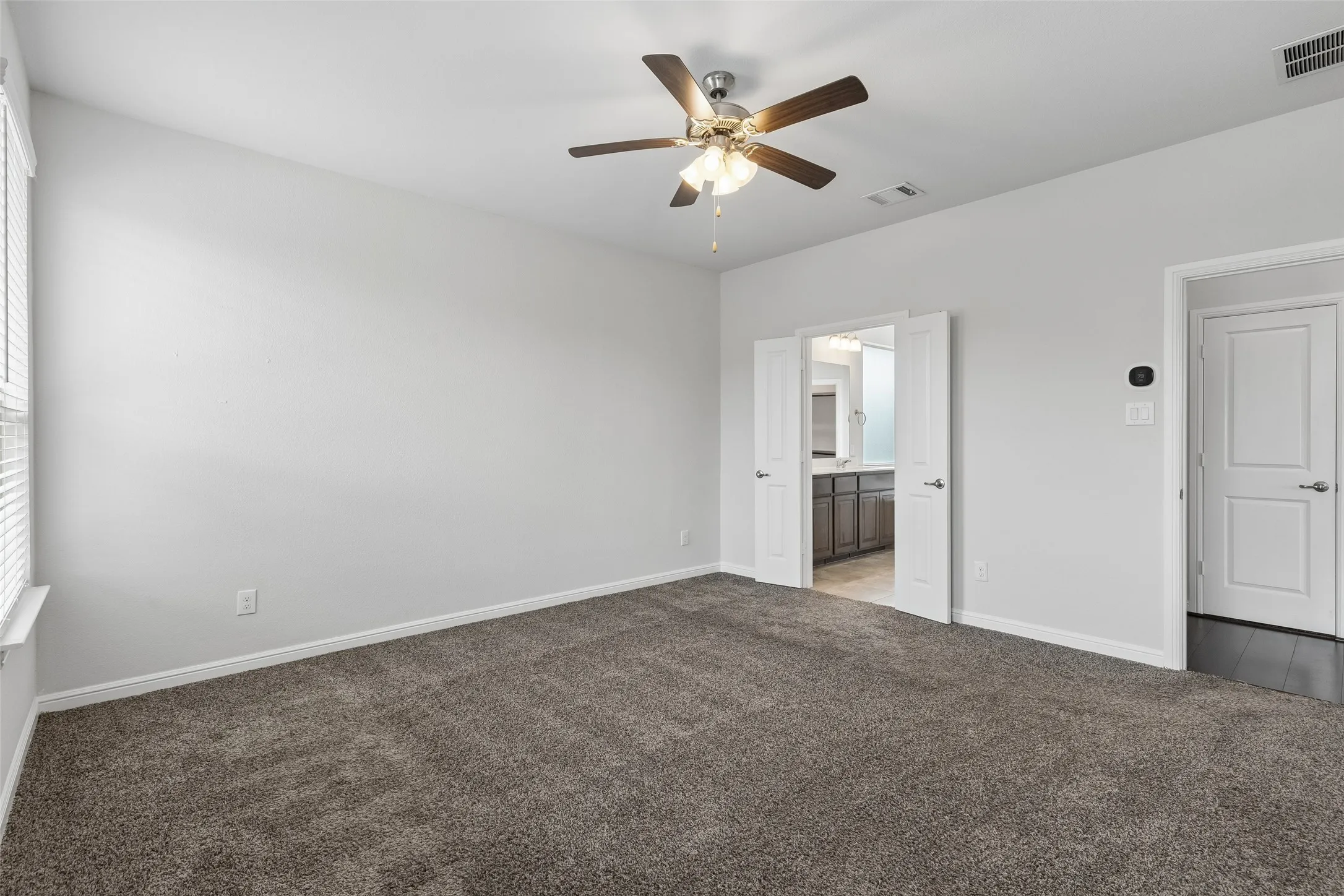 Primary bedroom is large and overlooks the backyard.