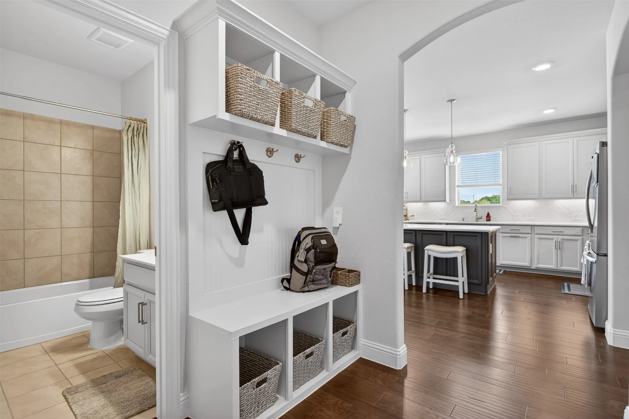 Built-in mudroom bench with cubby storage and coat hooks