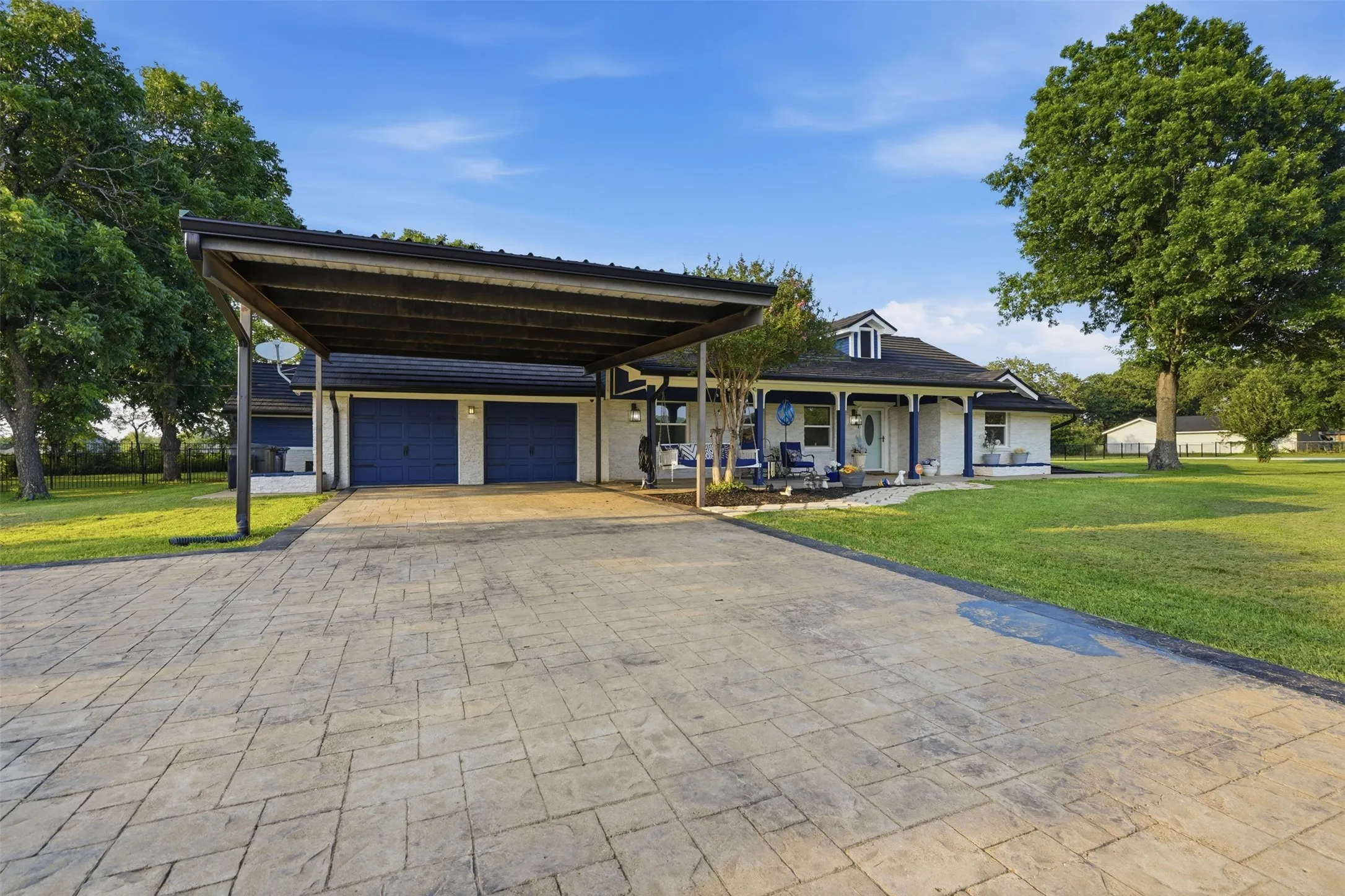 White brick exterior with a covered front porch featuring blue columns and trim