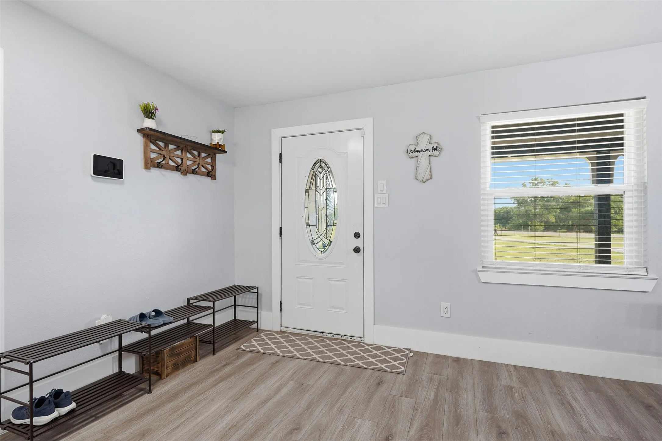 Entryway with wood-finish flooring and light gray walls