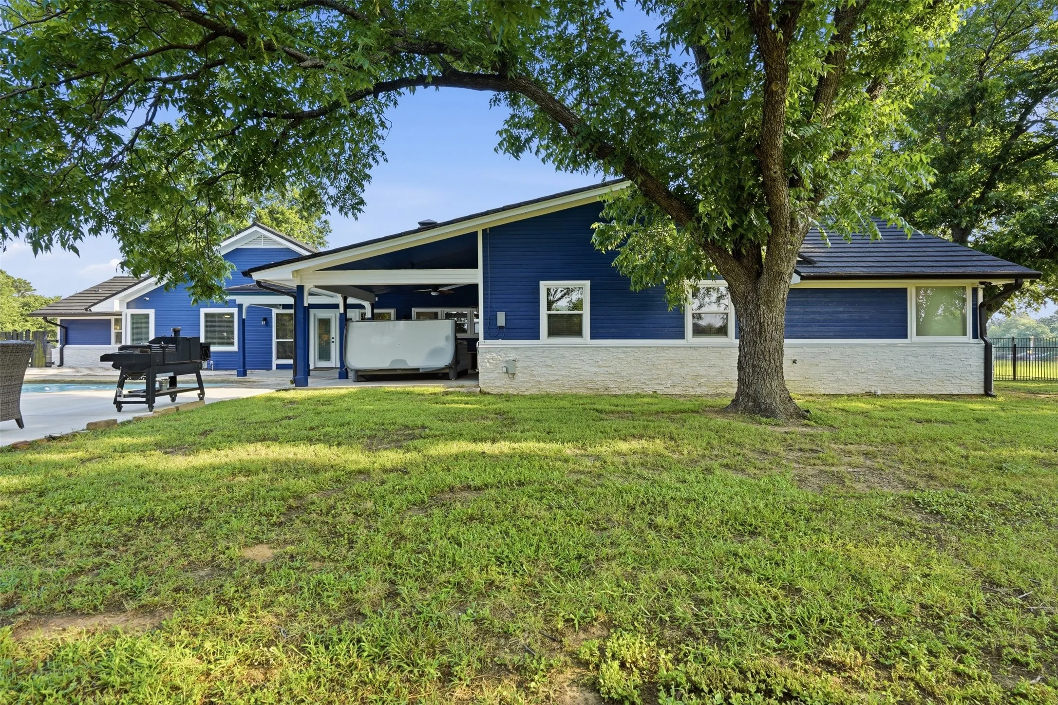 Blue siding exterior with white stone veneer accents