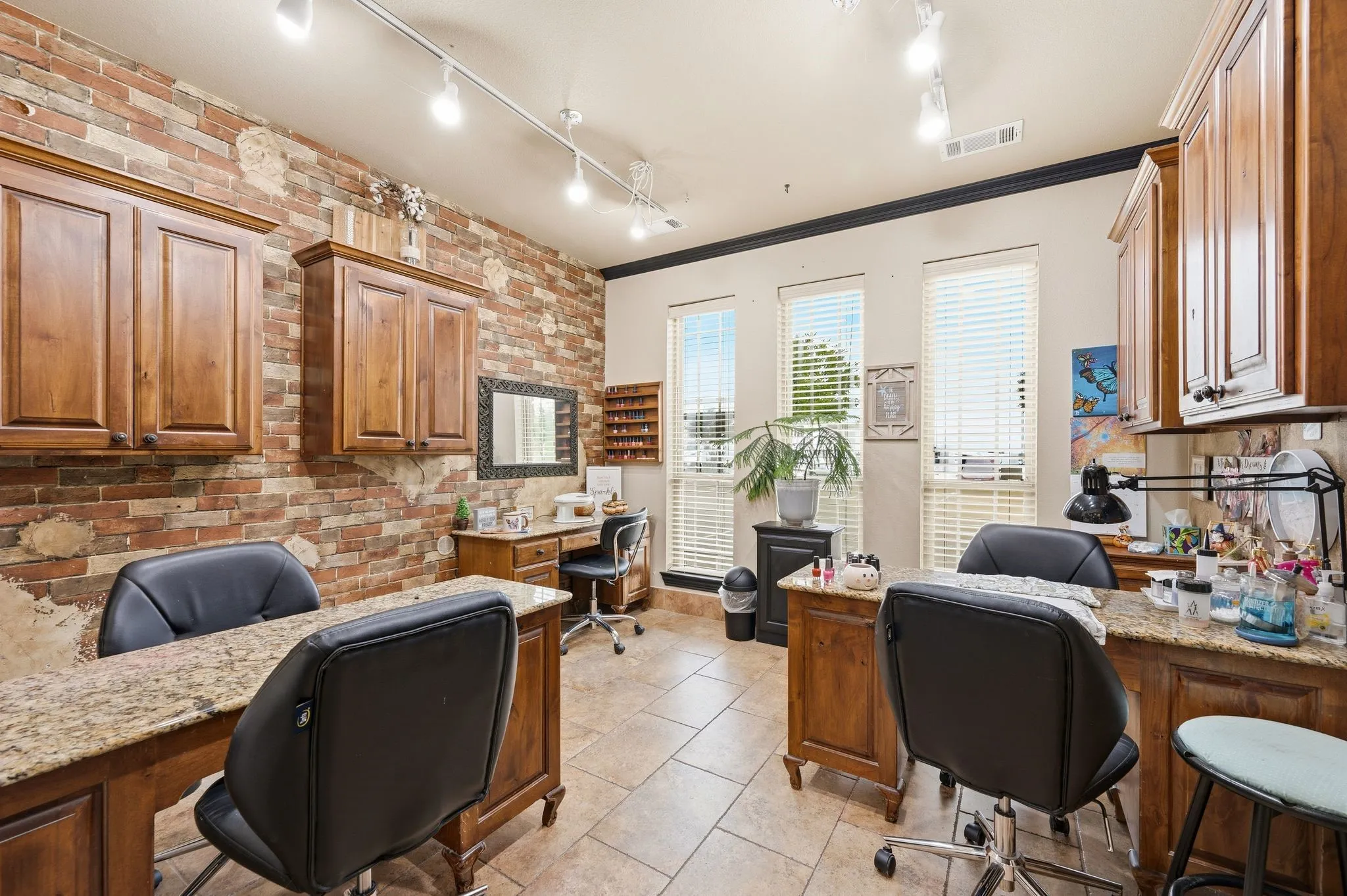Exposed brick accent wall with wood-finish cabinetry