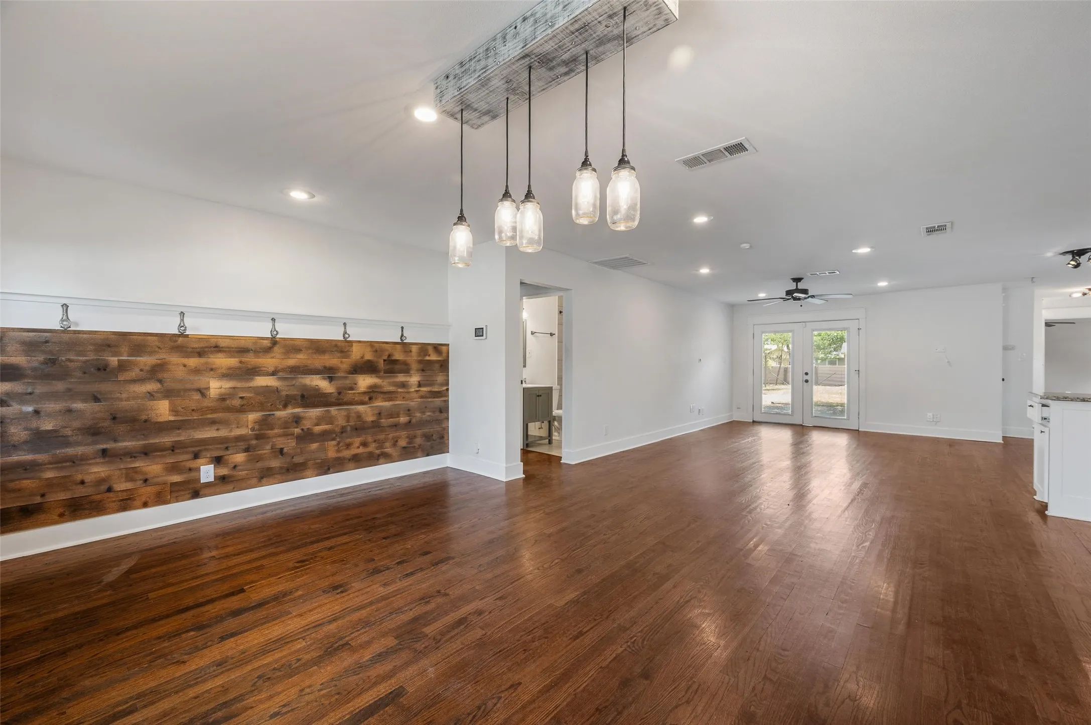 Entryway with wood wall accent and original 1942 door knobs used as coat racks