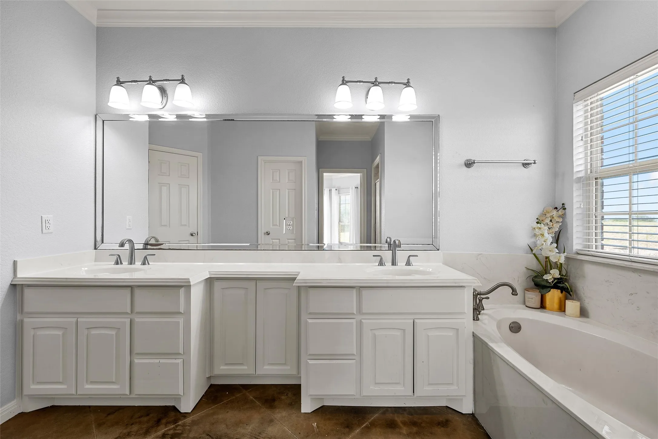 Double vanity with white cabinetry and integrated sinks