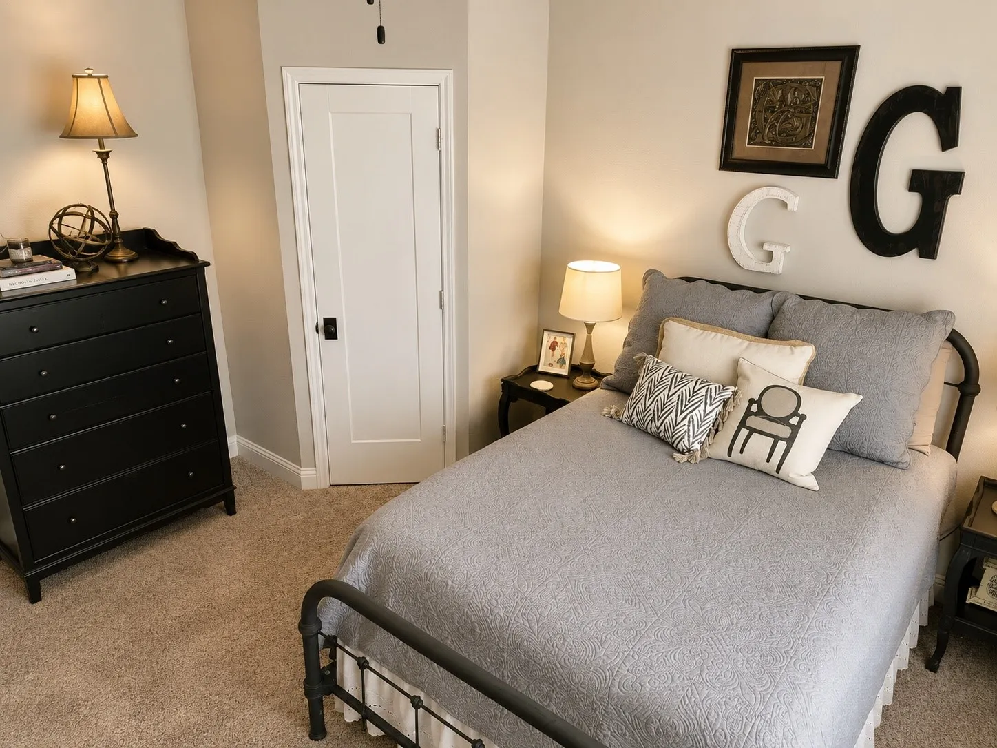 Carpeted room featuring a white single-panel interior door with matte black hardware, light neutral wall paint, and white baseboards