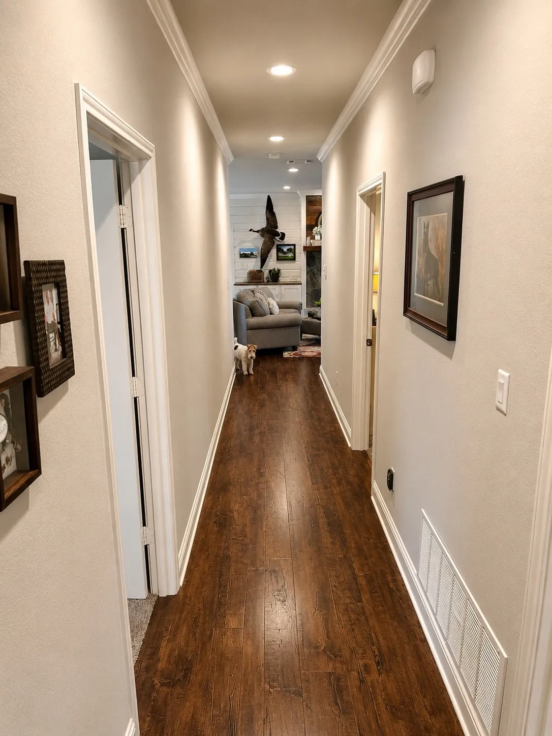 Corridor featuring wood-finish flooring, recessed lighting, crown molding, and crisp white trim
