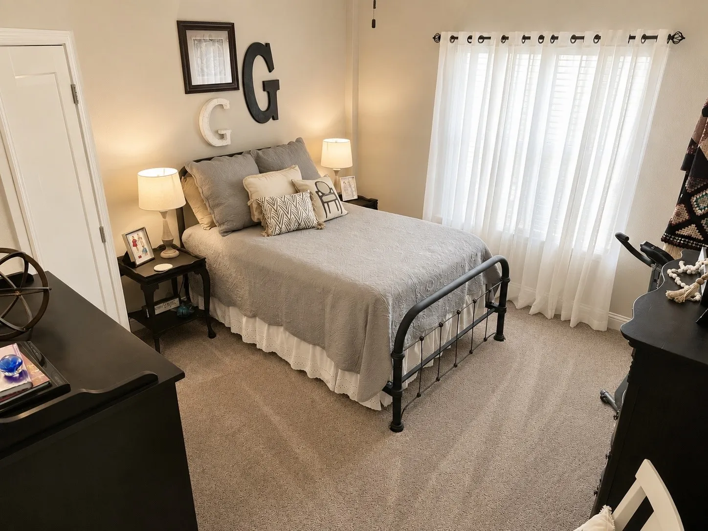 Carpeted room with a full-height white door and light neutral wall color