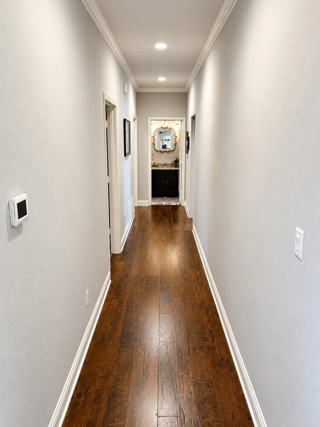Hallway featuring wood-finish flooring, recessed lighting, and crown molding