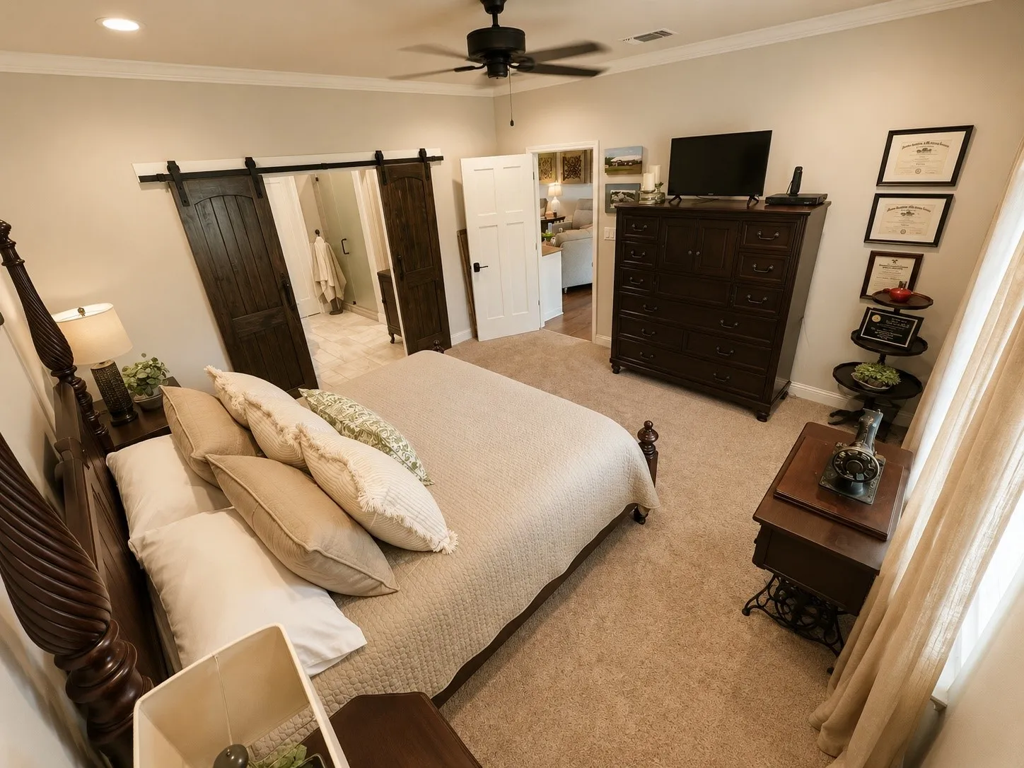 Spacious room featuring carpet flooring, crown molding, a ceiling fan, and a barn door entry to an additional space with tile flooring