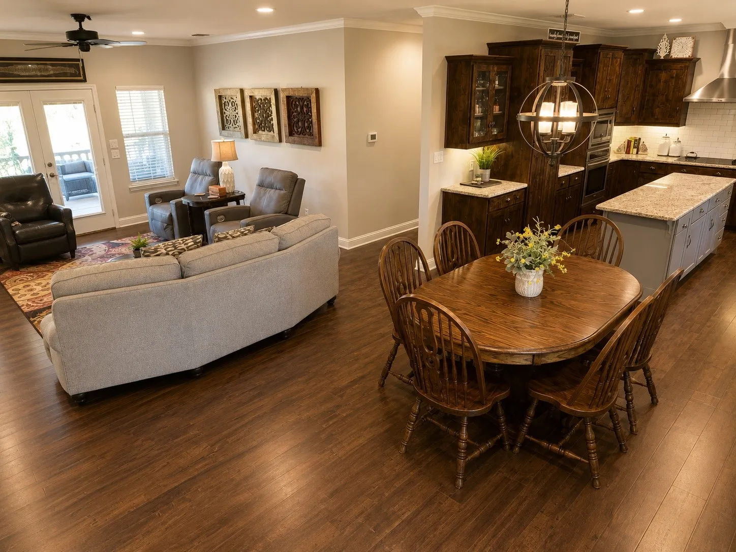 Open-concept living area featuring wood-finish flooring, recessed lighting, and crown molding