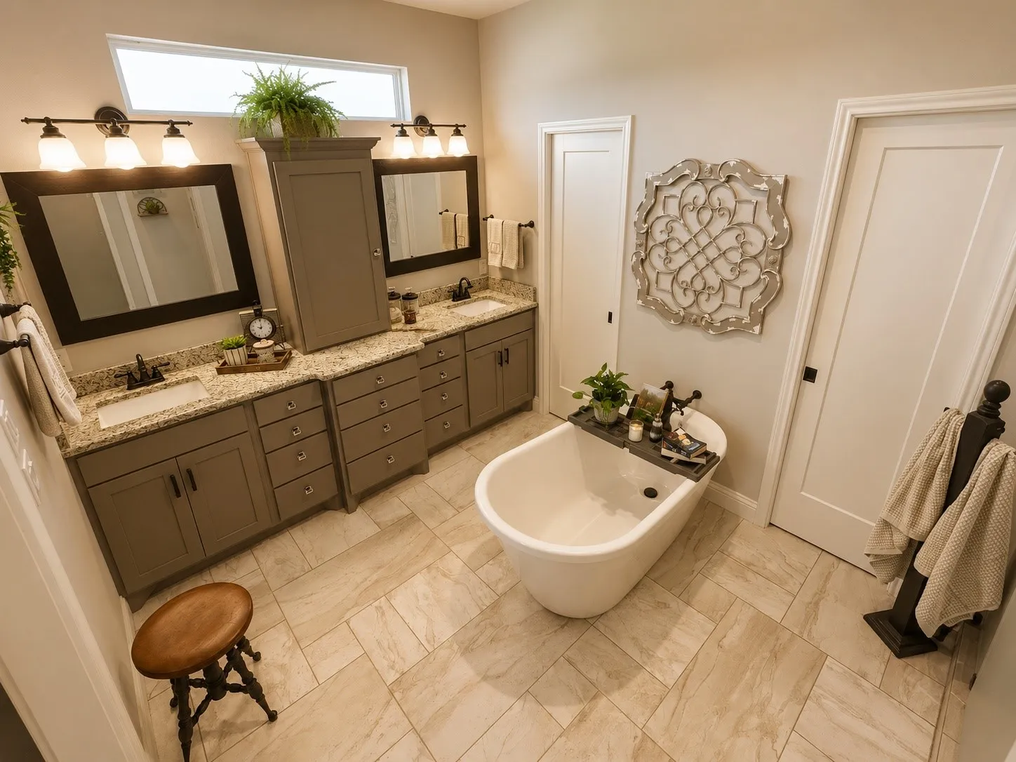 Bathroom featuring a freestanding soaking tub, dual vanity with undermount sinks, and stone countertops