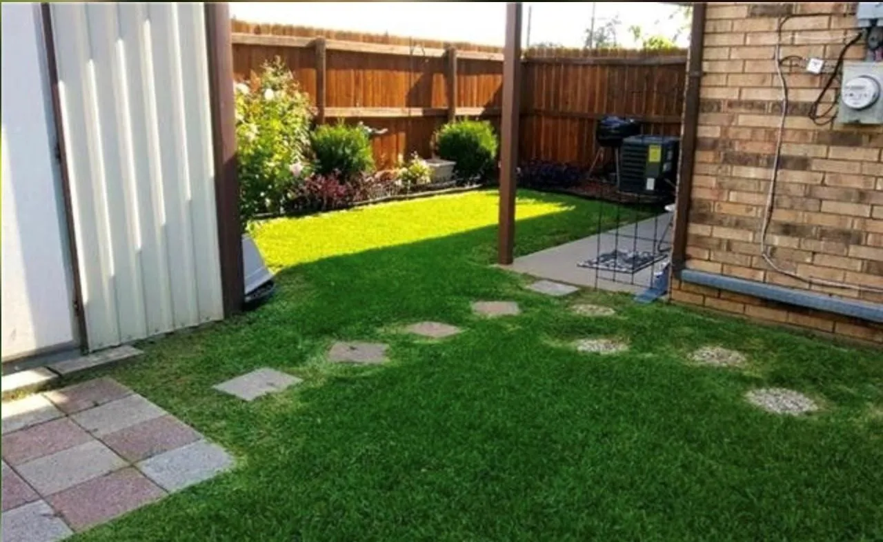 Private backyard with a wood fence perimeter and mature landscaping