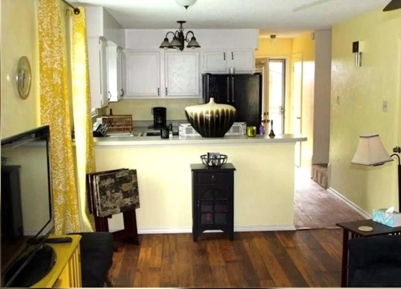 Open-concept living area featuring wood-finish flooring