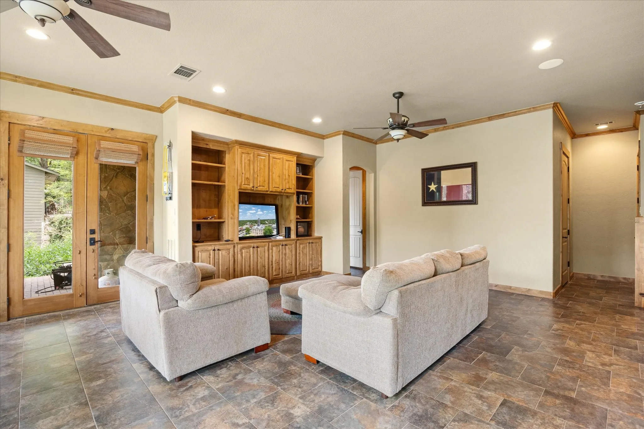Living area featuring wood-finish trim, recessed lighting, and dual ceiling fans