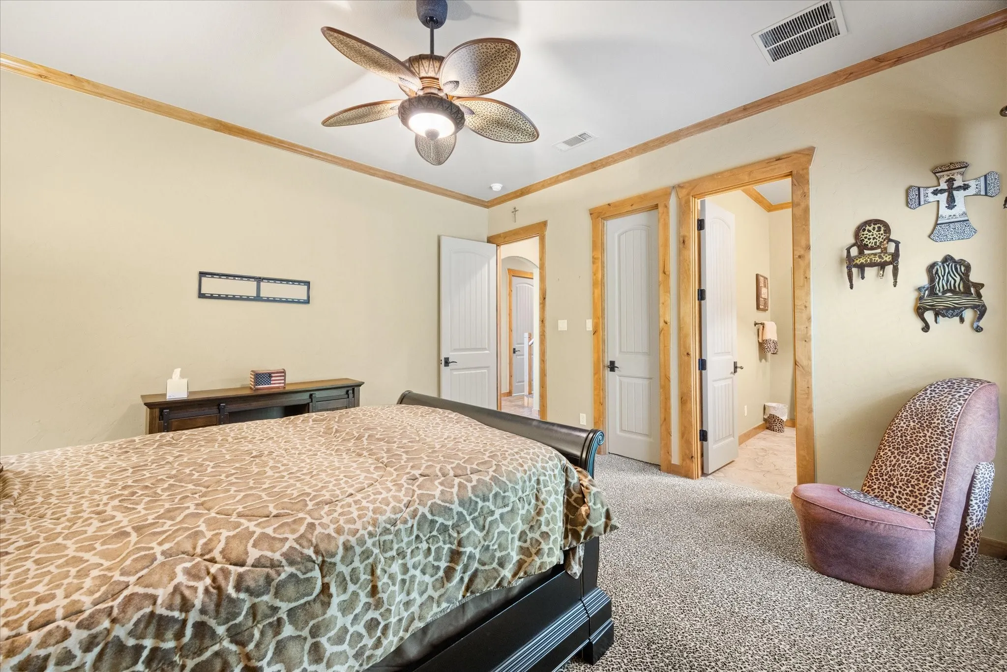 Carpeted room with natural wood trim framing doorways and ceiling lines
