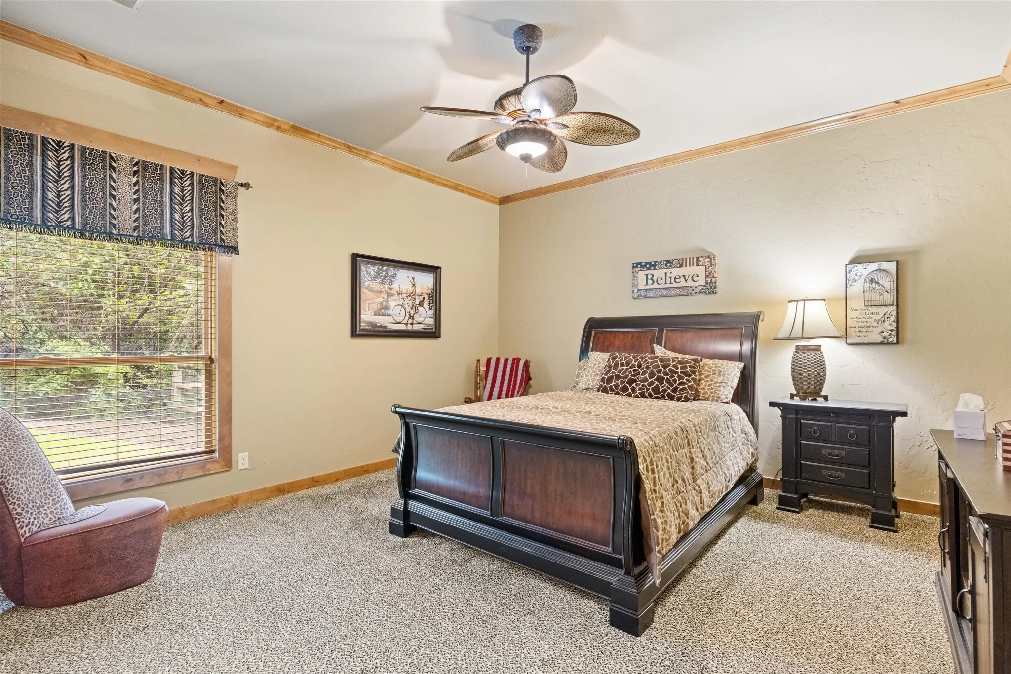 Spacious room featuring neutral wall tones, wood trim, and textured carpeting