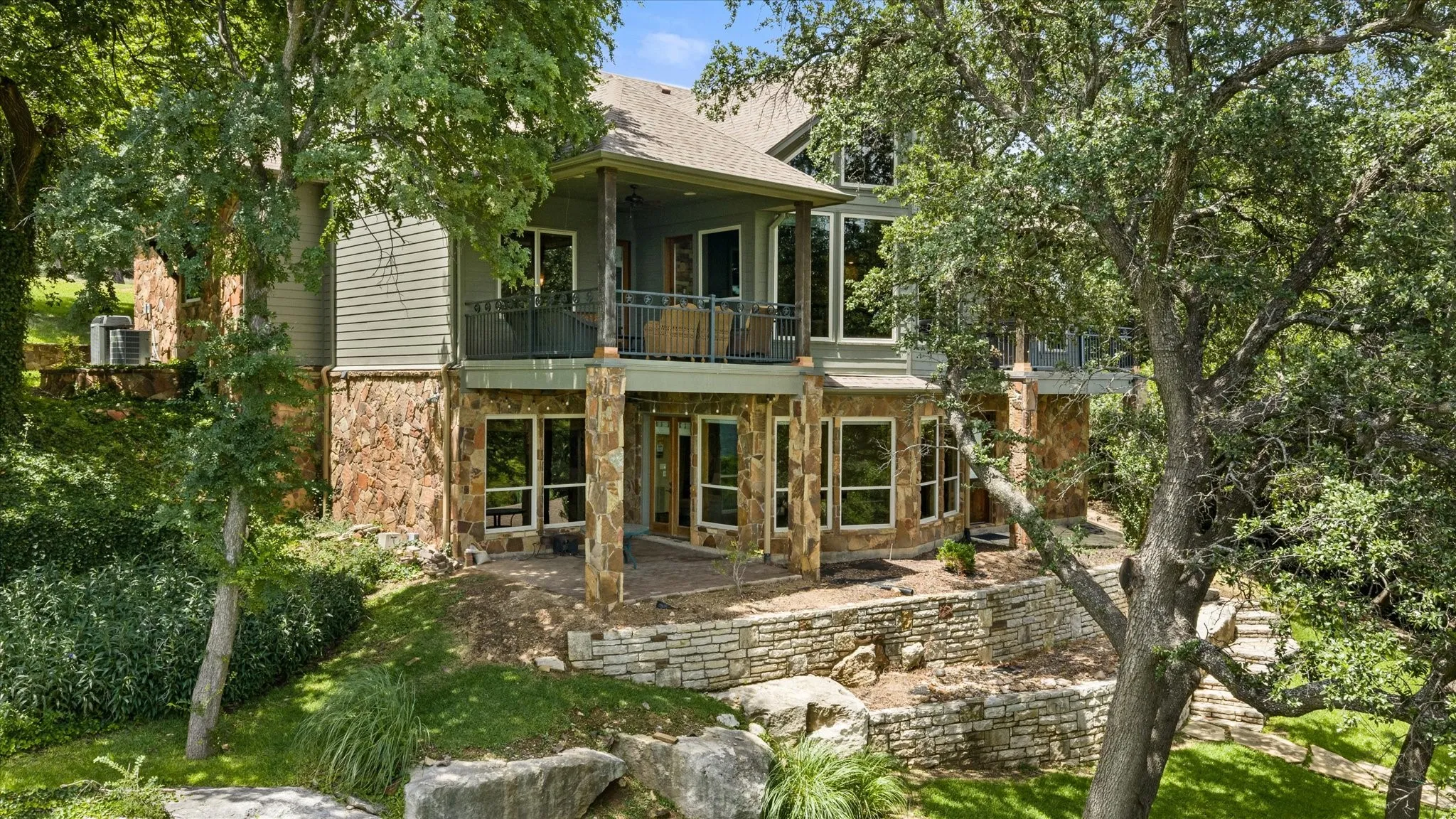 Multi-level property with a natural stone and siding exterior