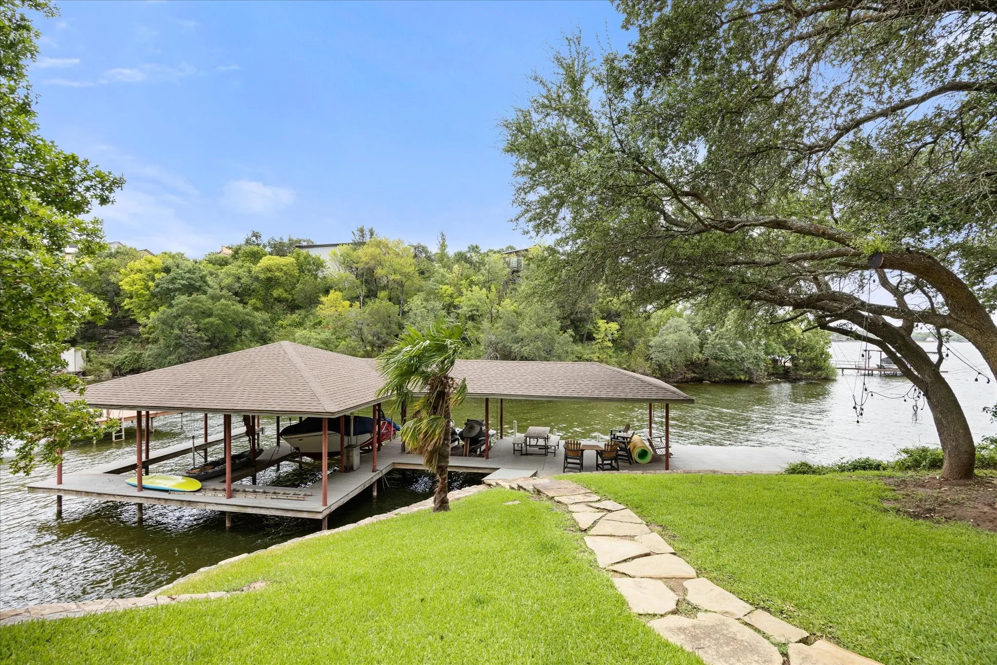 Waterfront boat dock featuring dual covered slips