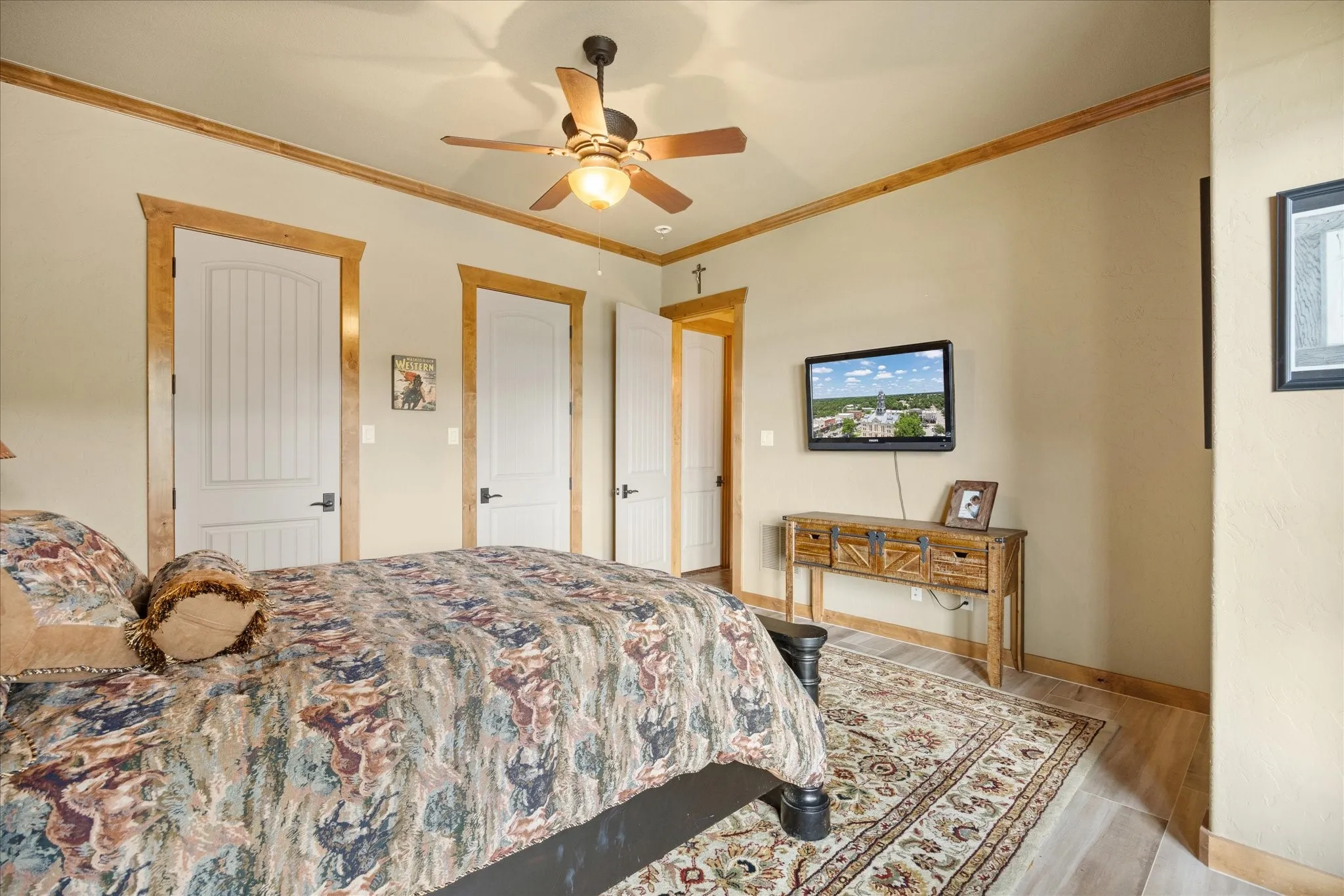 Interior room featuring light wood-finish flooring, light tan wall color, and a ceiling fan with integrated lighting