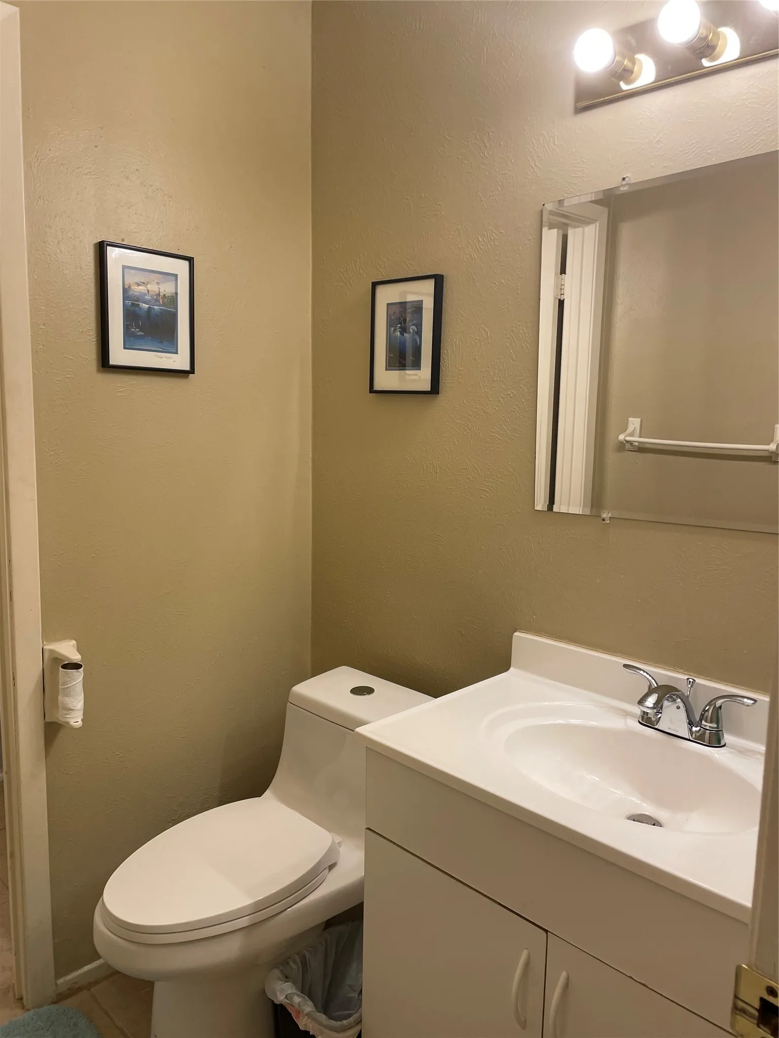 Half bath featuring vanity and tile patterned flooring