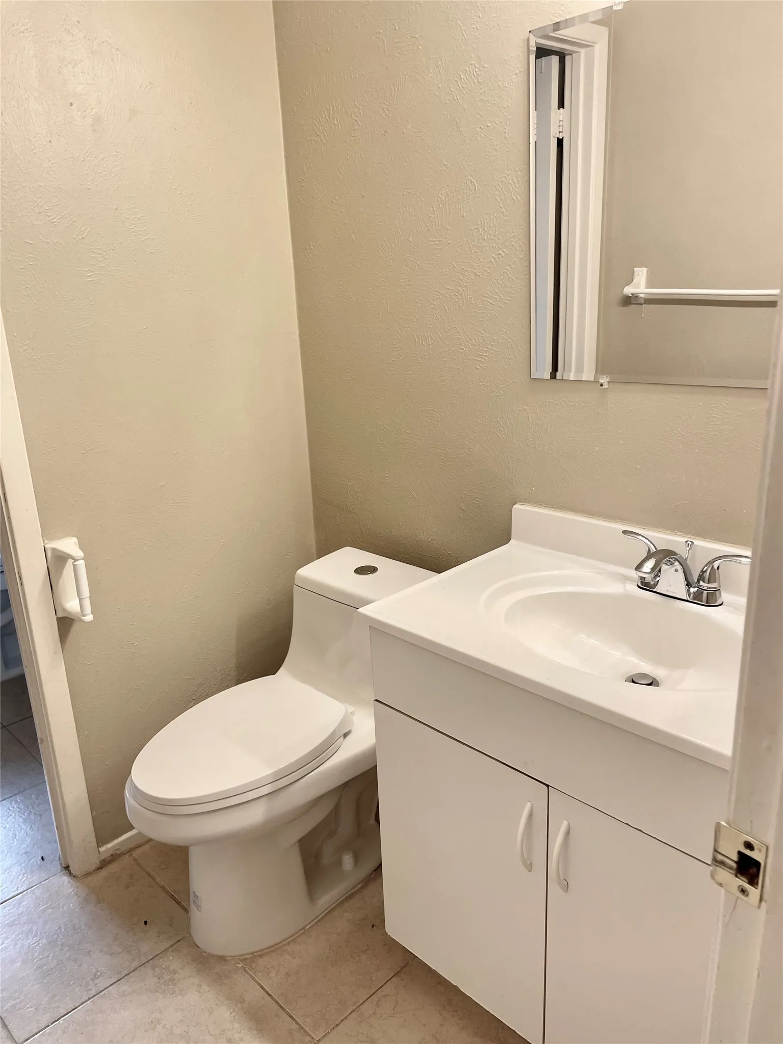 Half bath featuring vanity and tile patterned floors