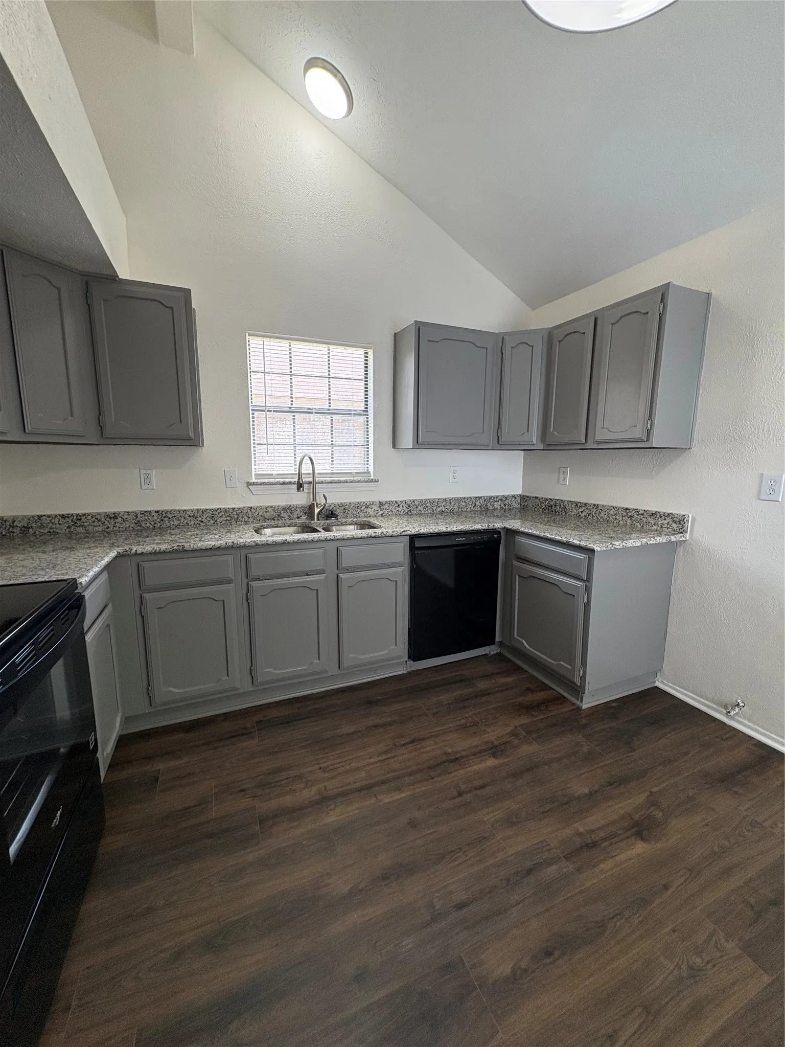 Kitchen featuring a vaulted ceiling and recessed lighting