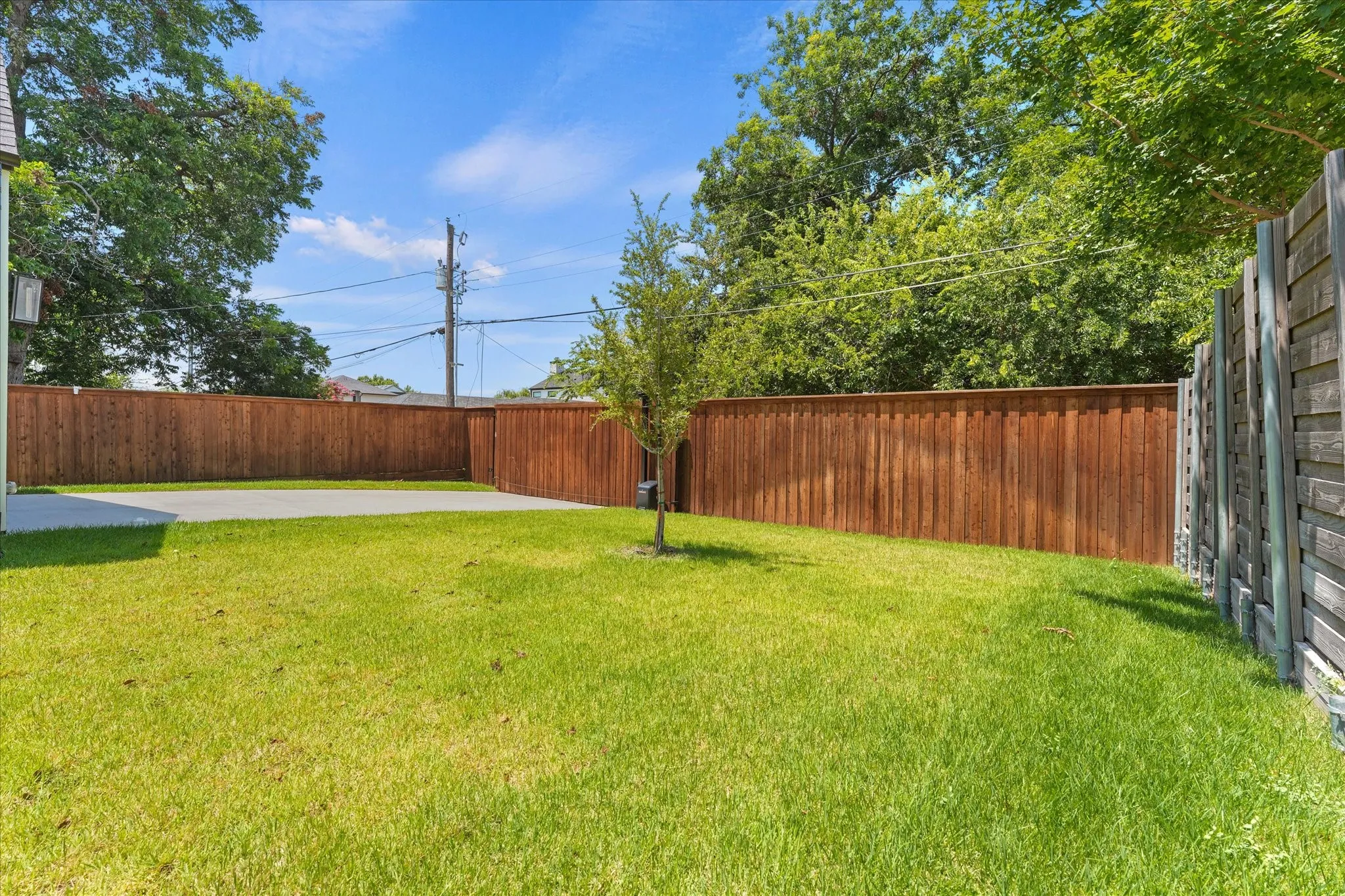 view of driveway and rear entry electric gate