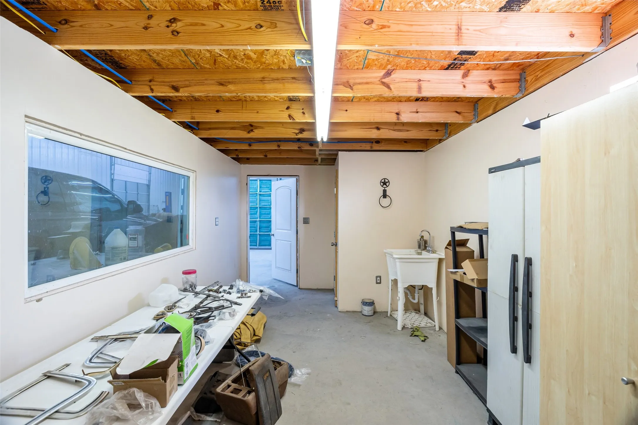 Misc room featuring unfinished concrete flooring