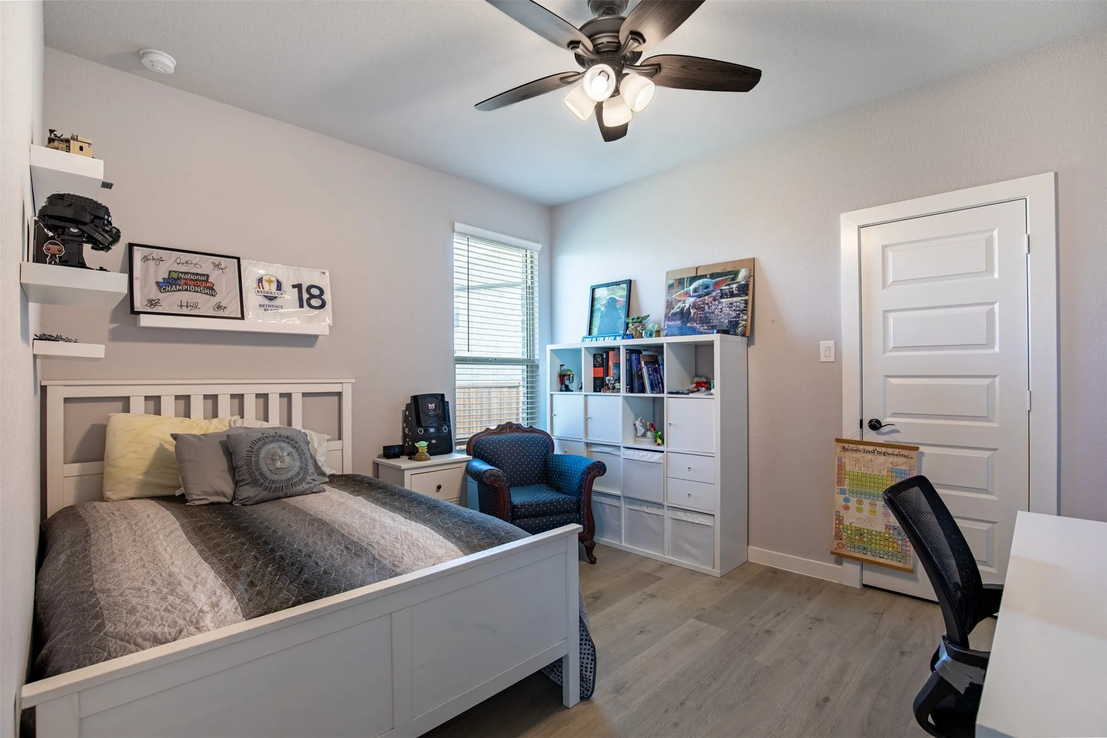 Secondary bedroom with ceiling fan and walk-in closet.