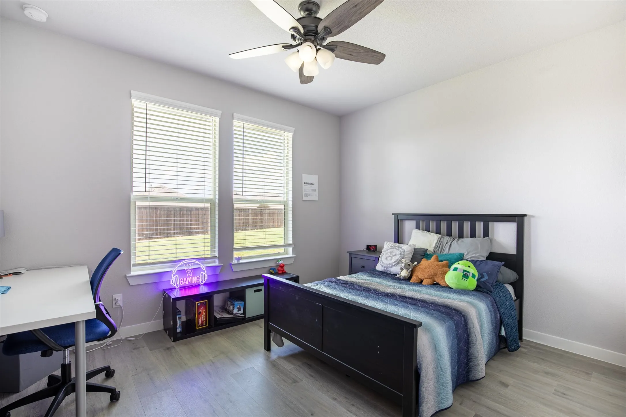 Secondary bedroom with ceiling fan and walk-in closet.