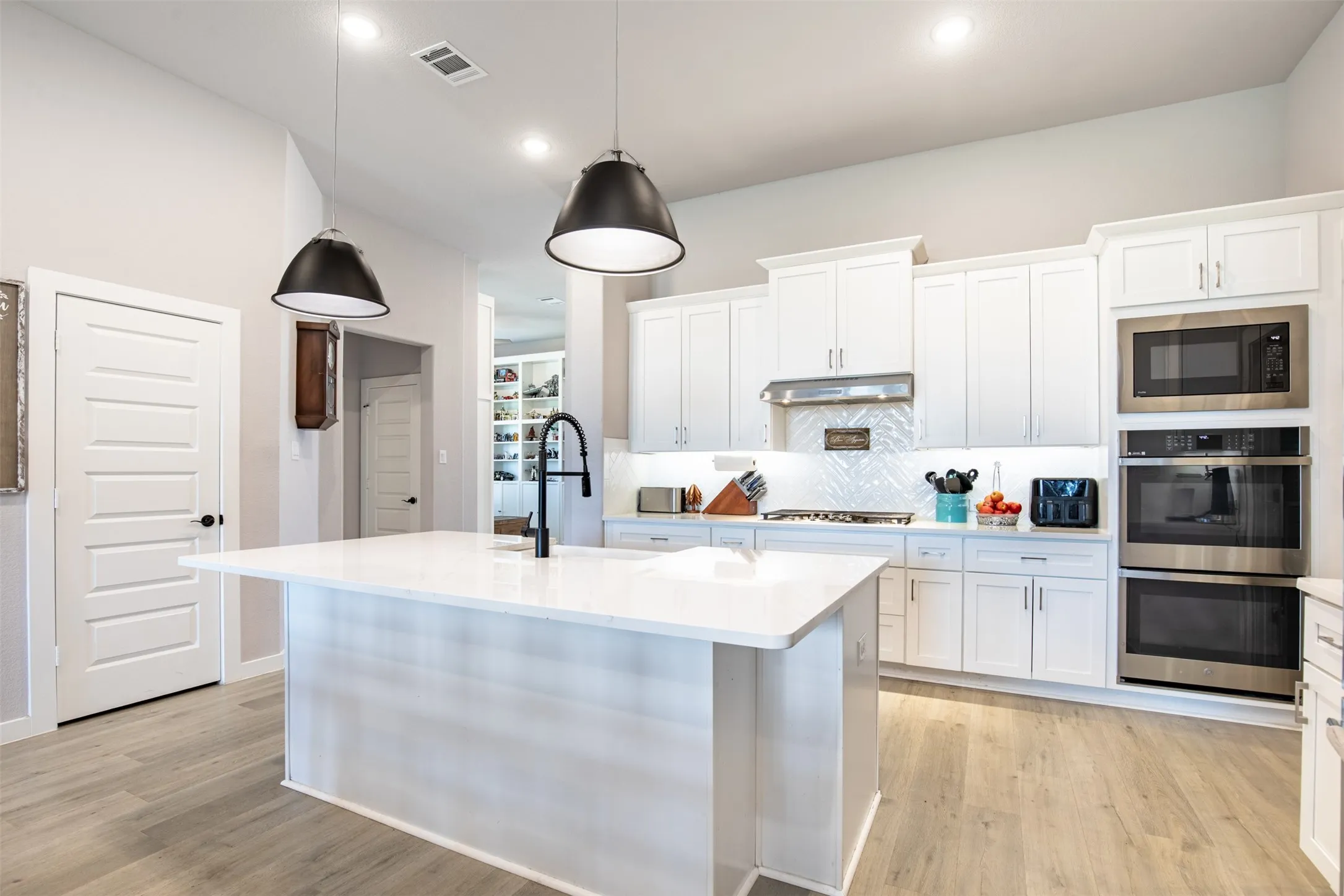 Gourmet kitchen with pristine white cabinetry.