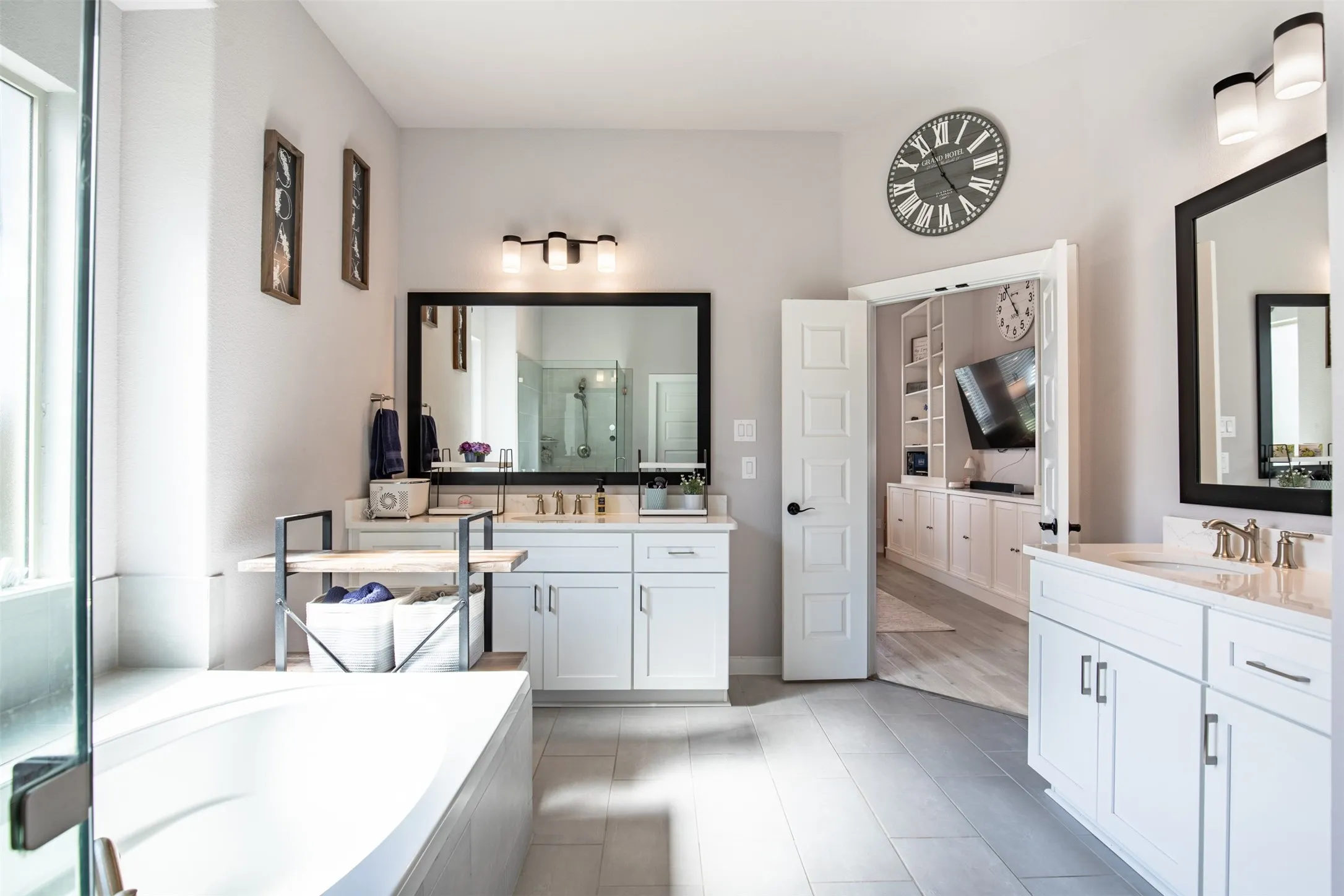 En-suite bath with dual vanities and double-door entrance.