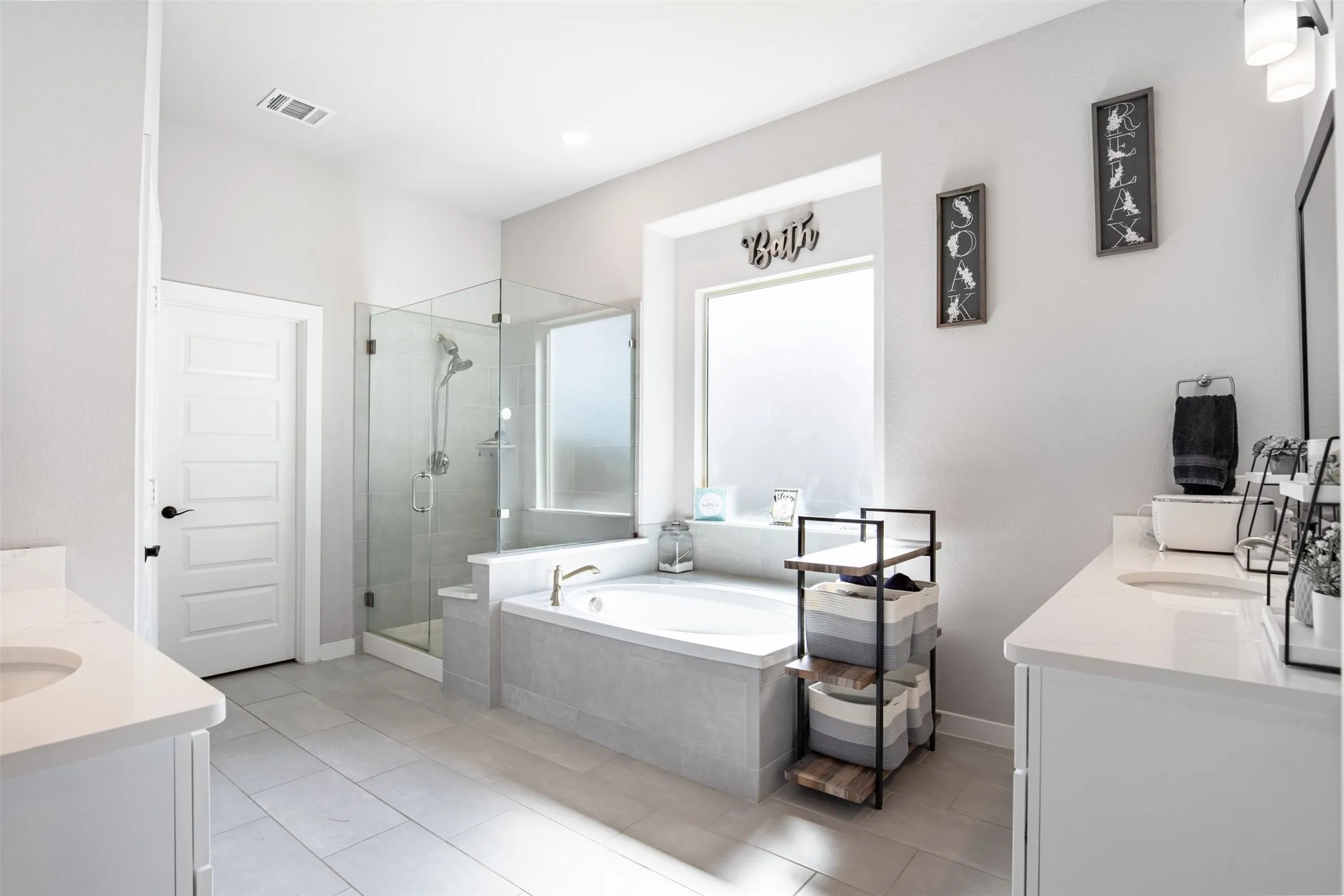 En-suite bath with soaking tub and oversized shower with bench.