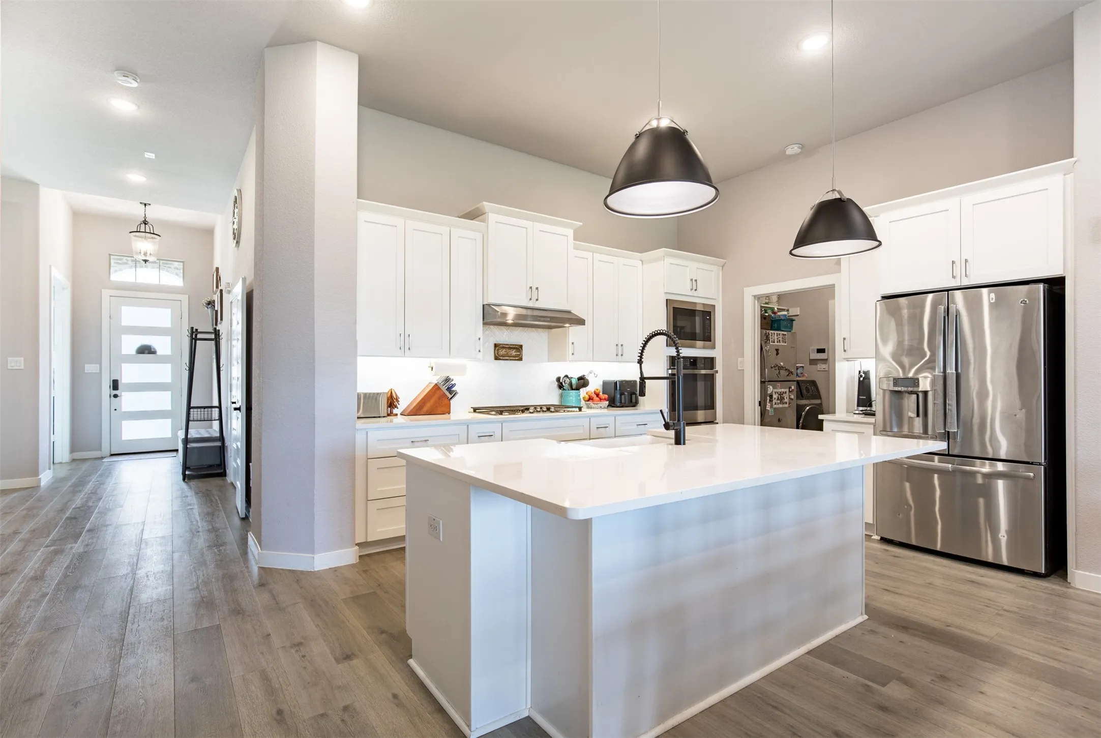 Oversized kitchen island with pendant lighting.