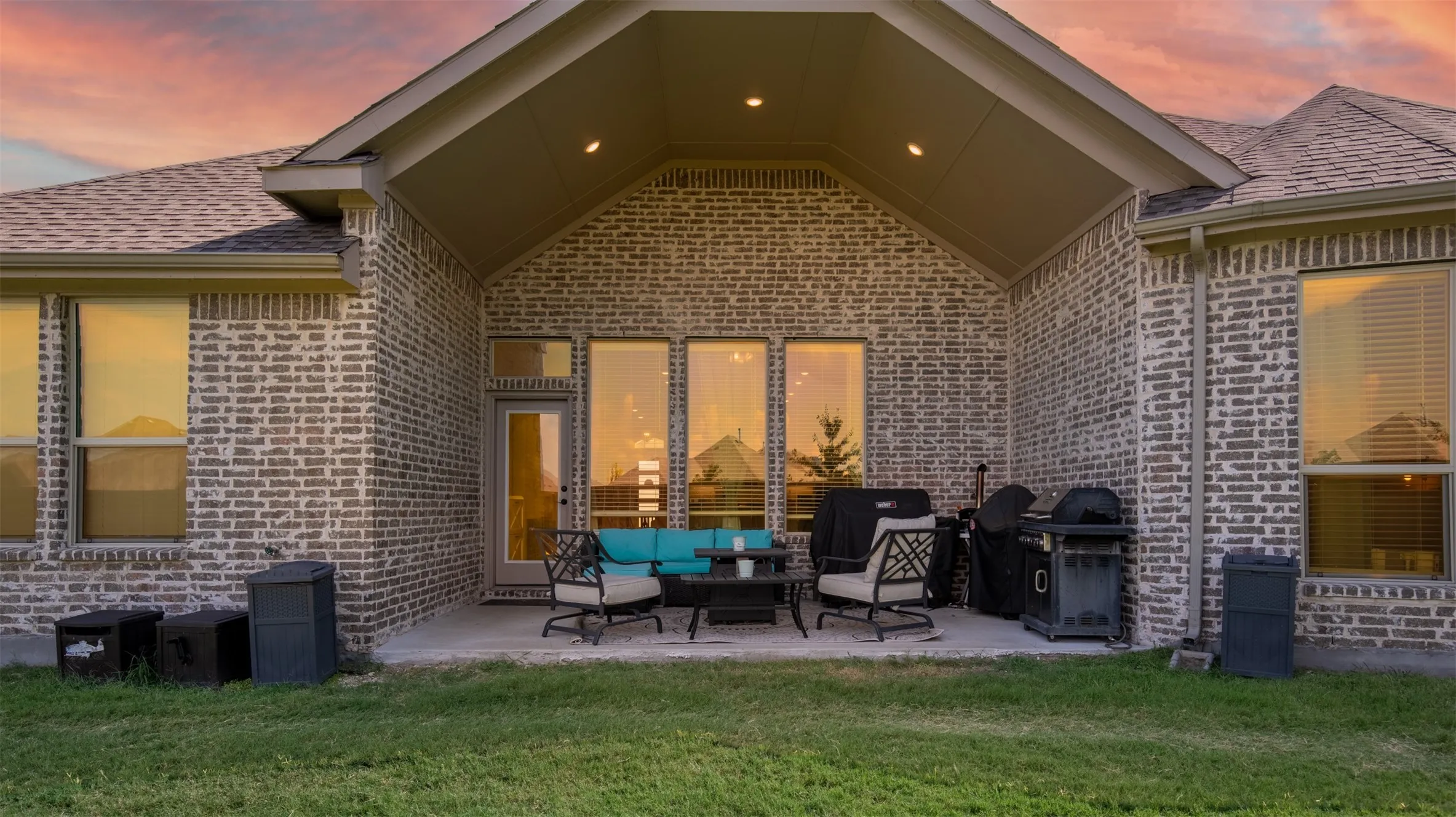 Covered patio with vaulted ceiling.