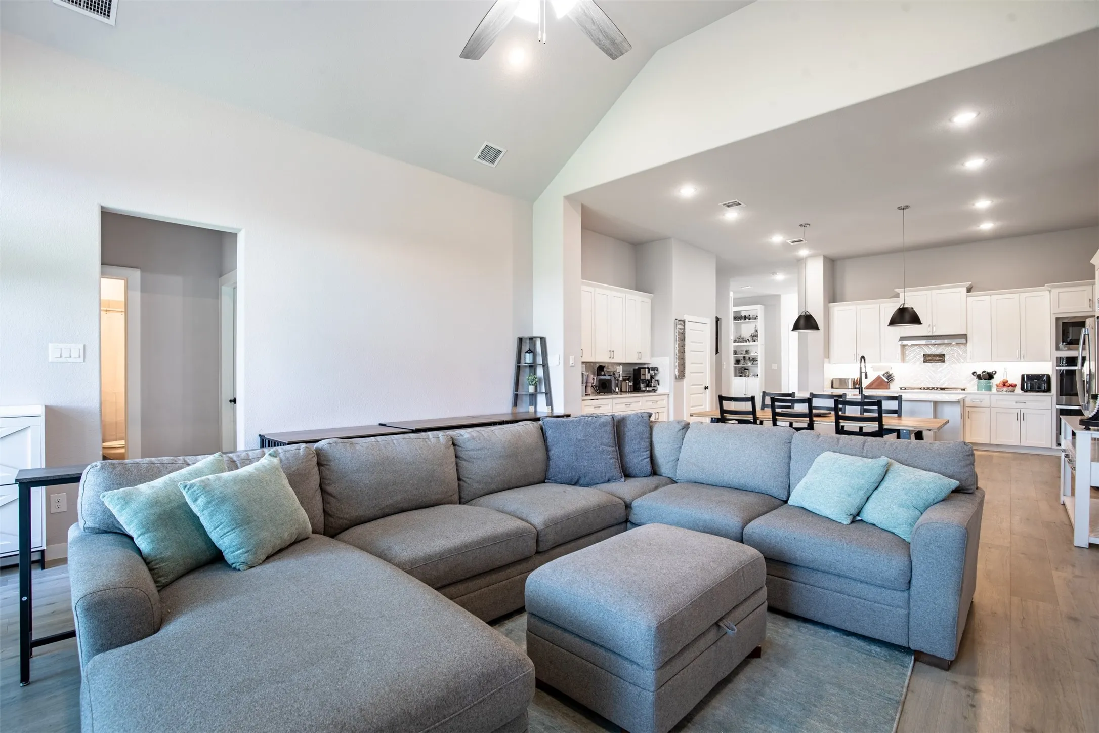 Open-concept living room to dining and kitchen.