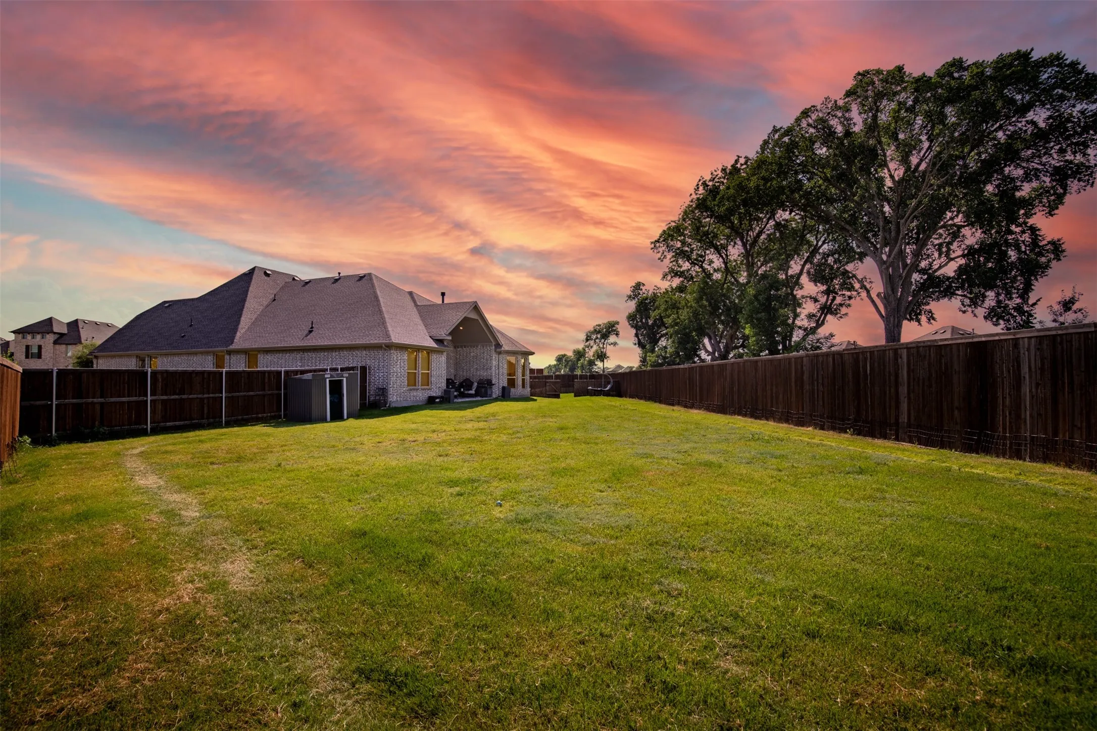 Spacious backyard surrounded by privacy fencing.