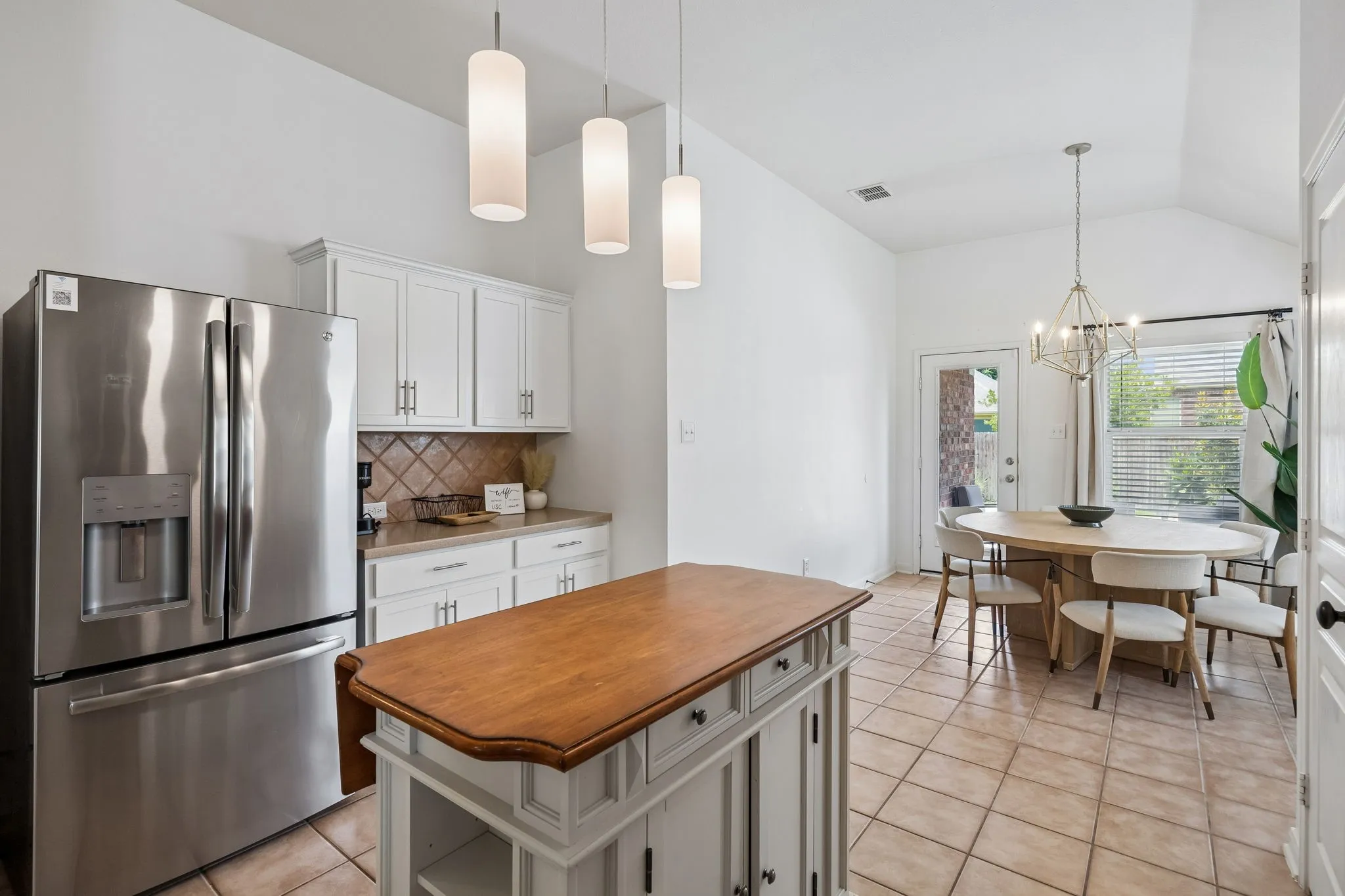 he heart of the home is an island kitchen - a chef’s delight  with adjacent dining.