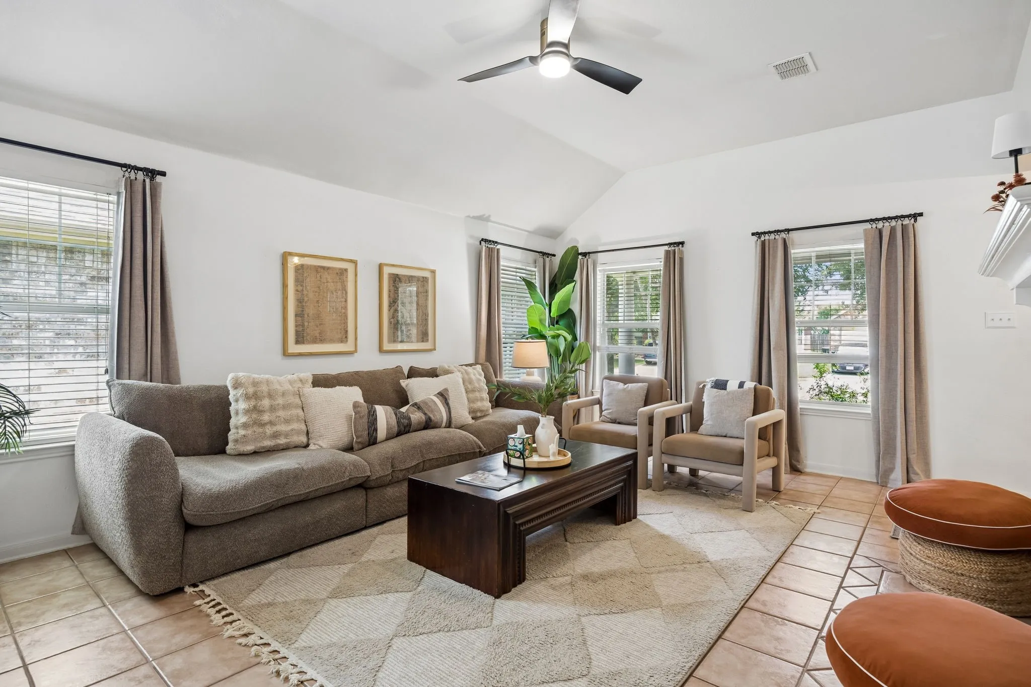 The living room is bathed in natural light by 4 large windows.