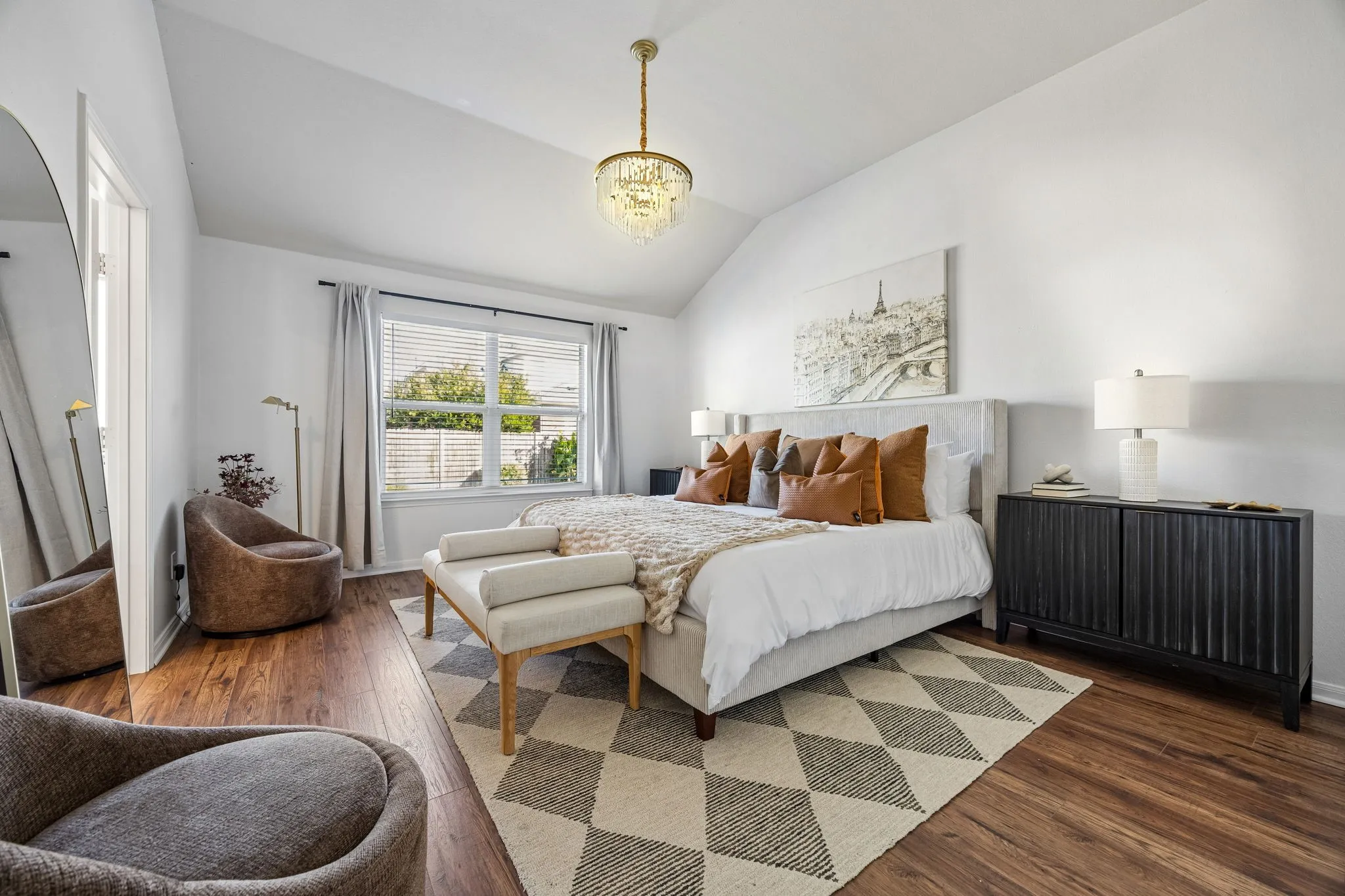 Spacious primary bedroom bathed in natural light.