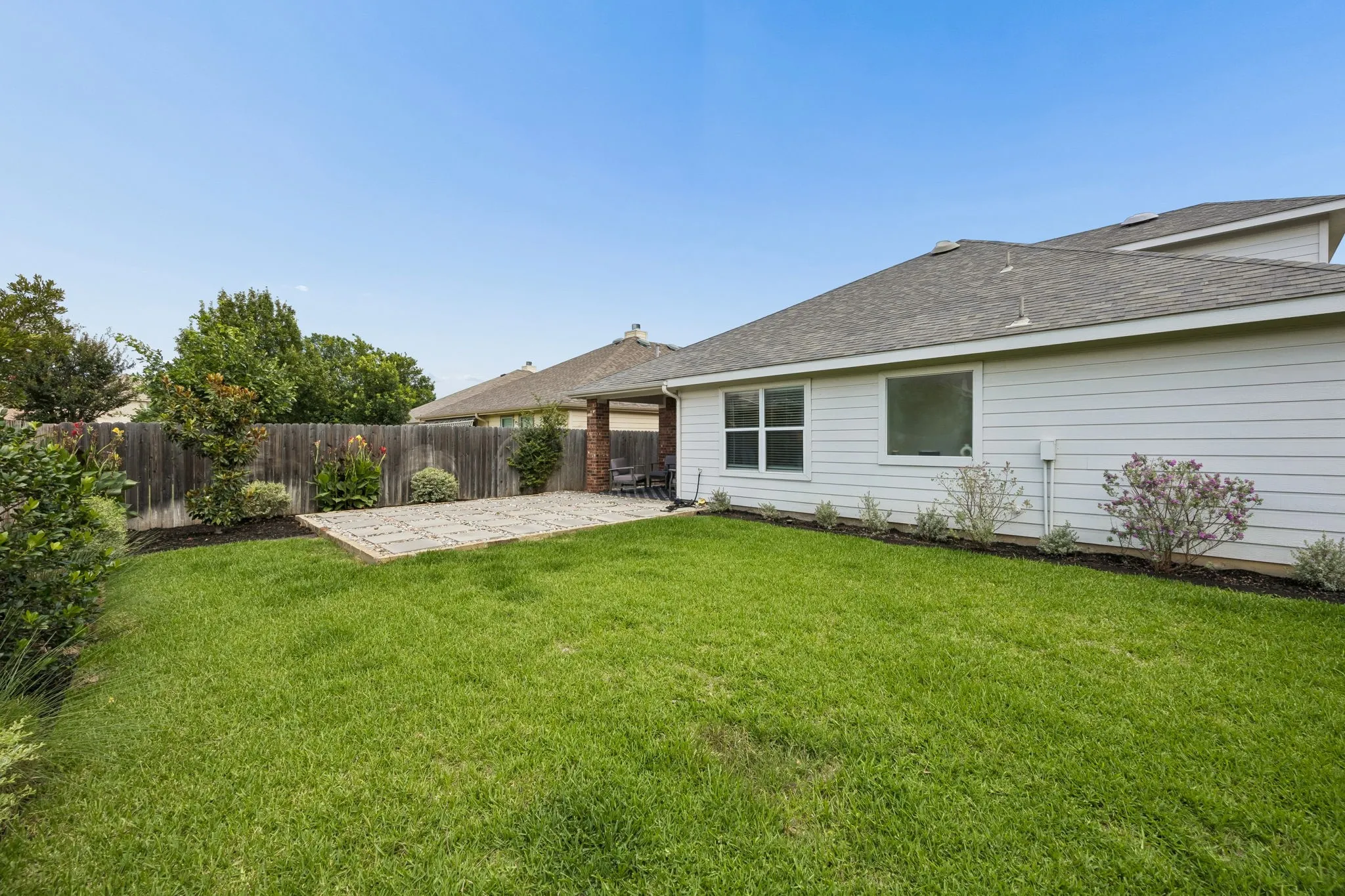 Backyard has plenty of lush grass area for kids, pets and outdoor enjoyment.